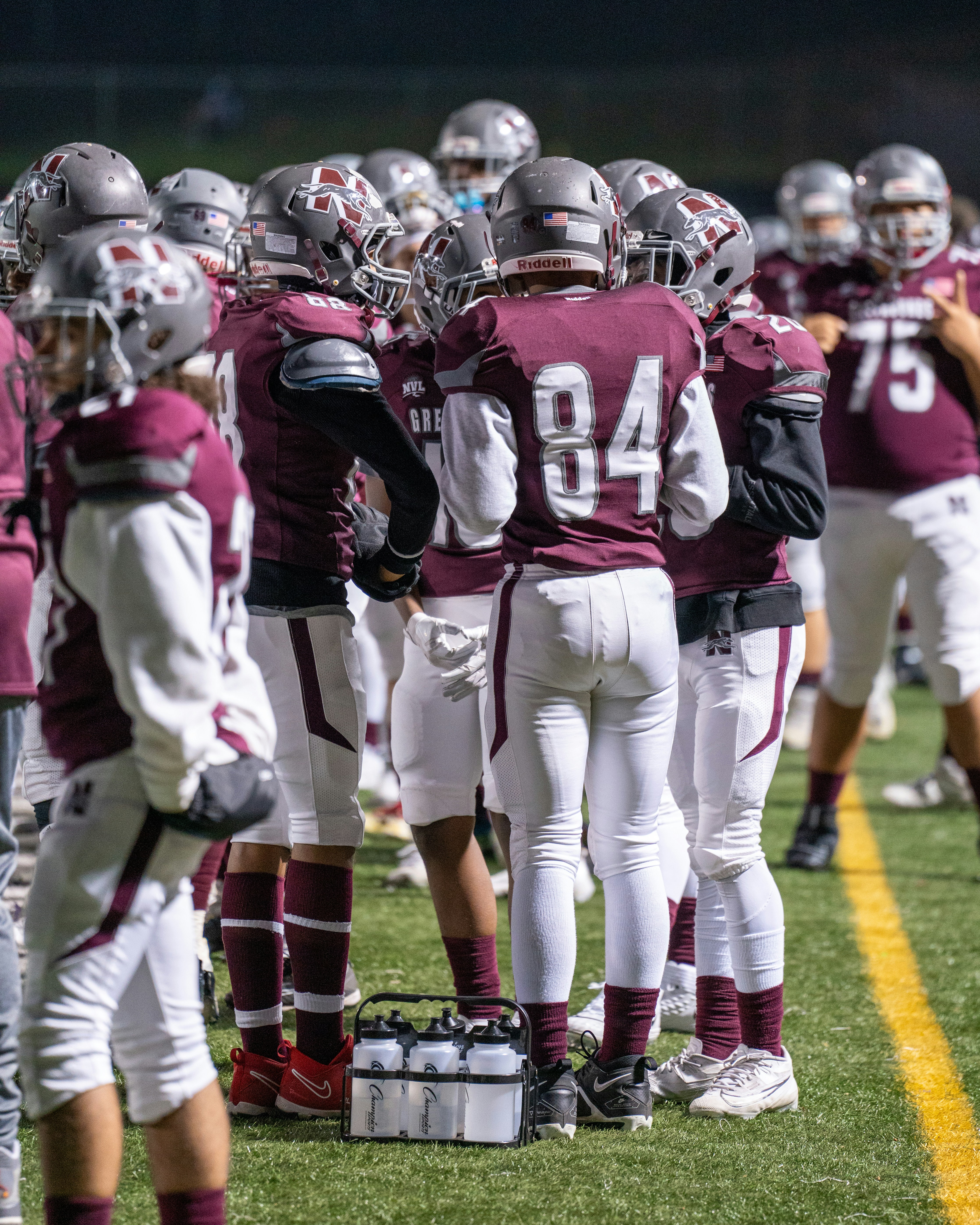 A group of football players standing on top of a field
