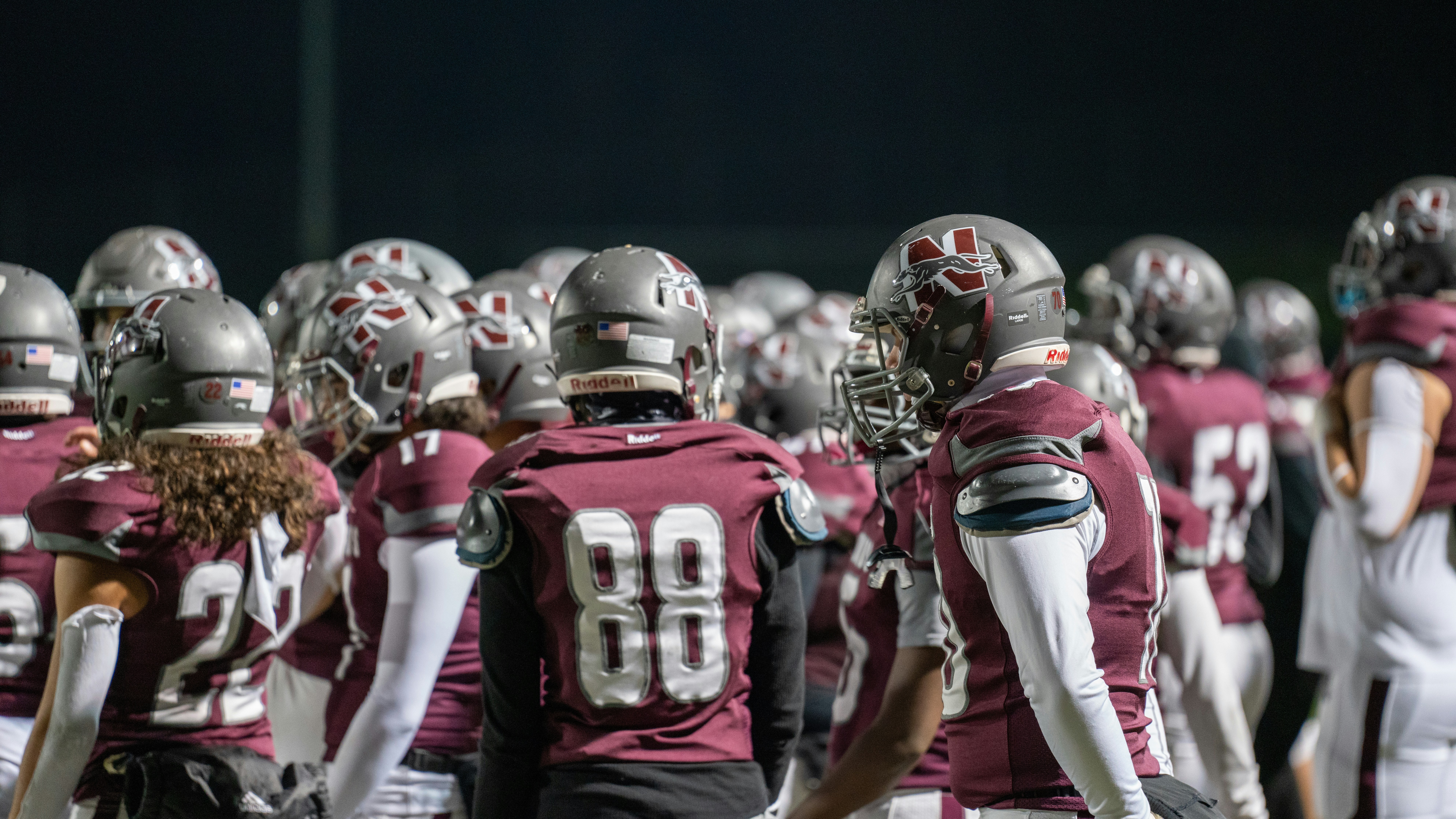A group of football players standing next to each other, 