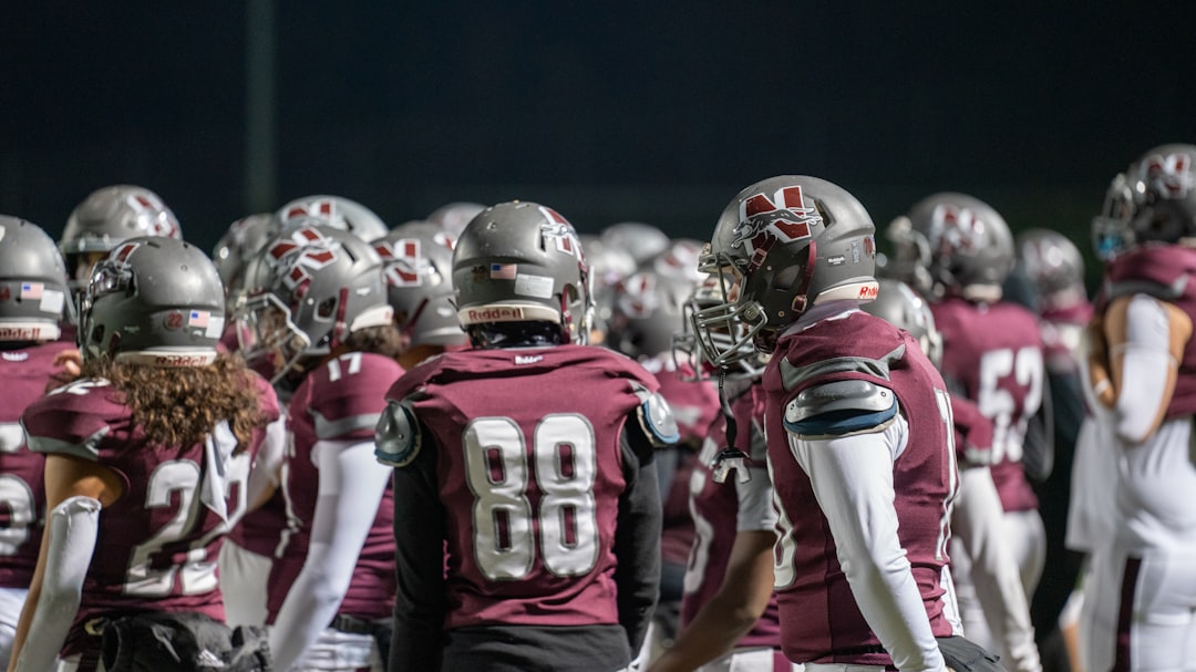 A group of football players standing next to each other,
