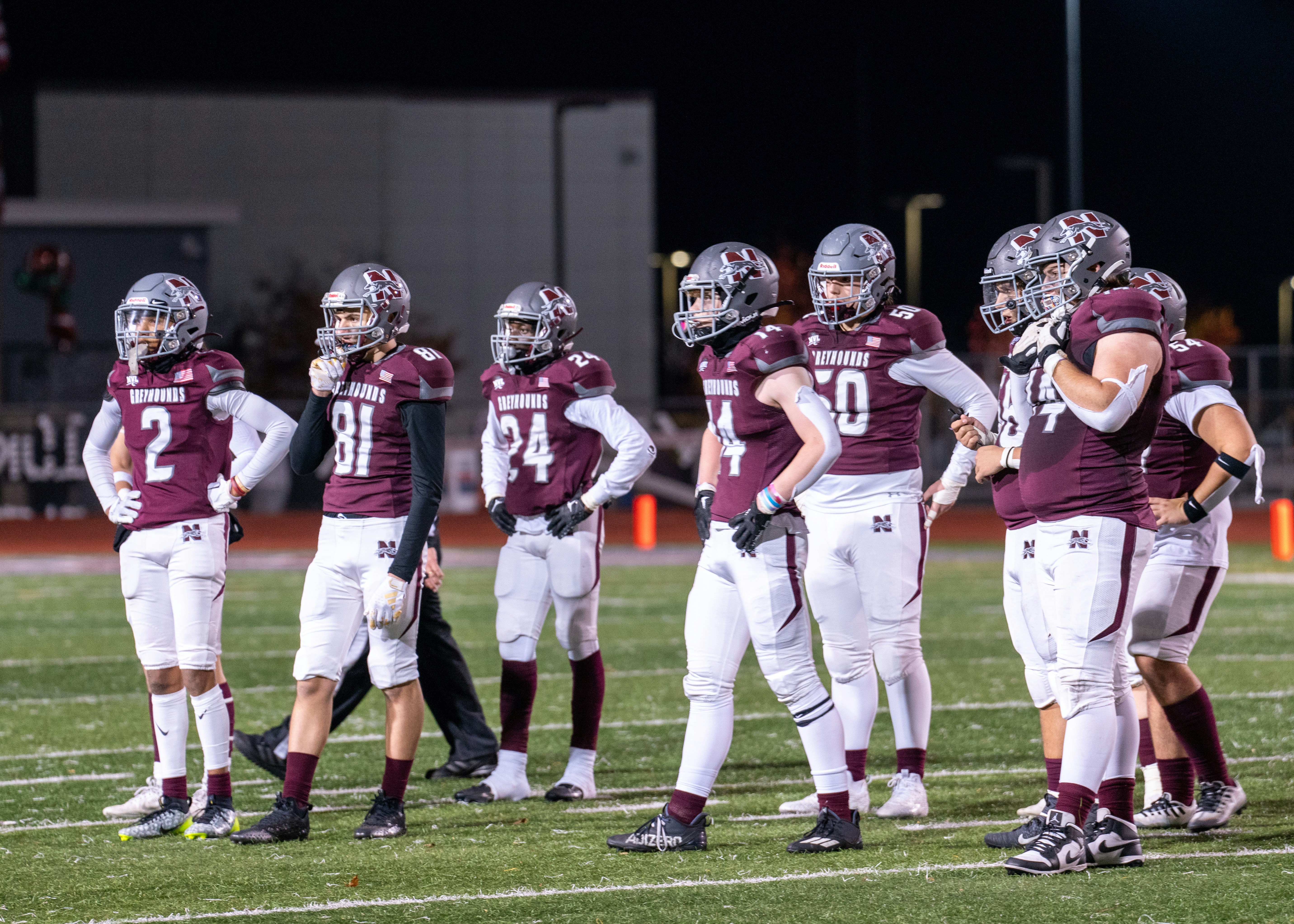 A group of football players standing on top of a field