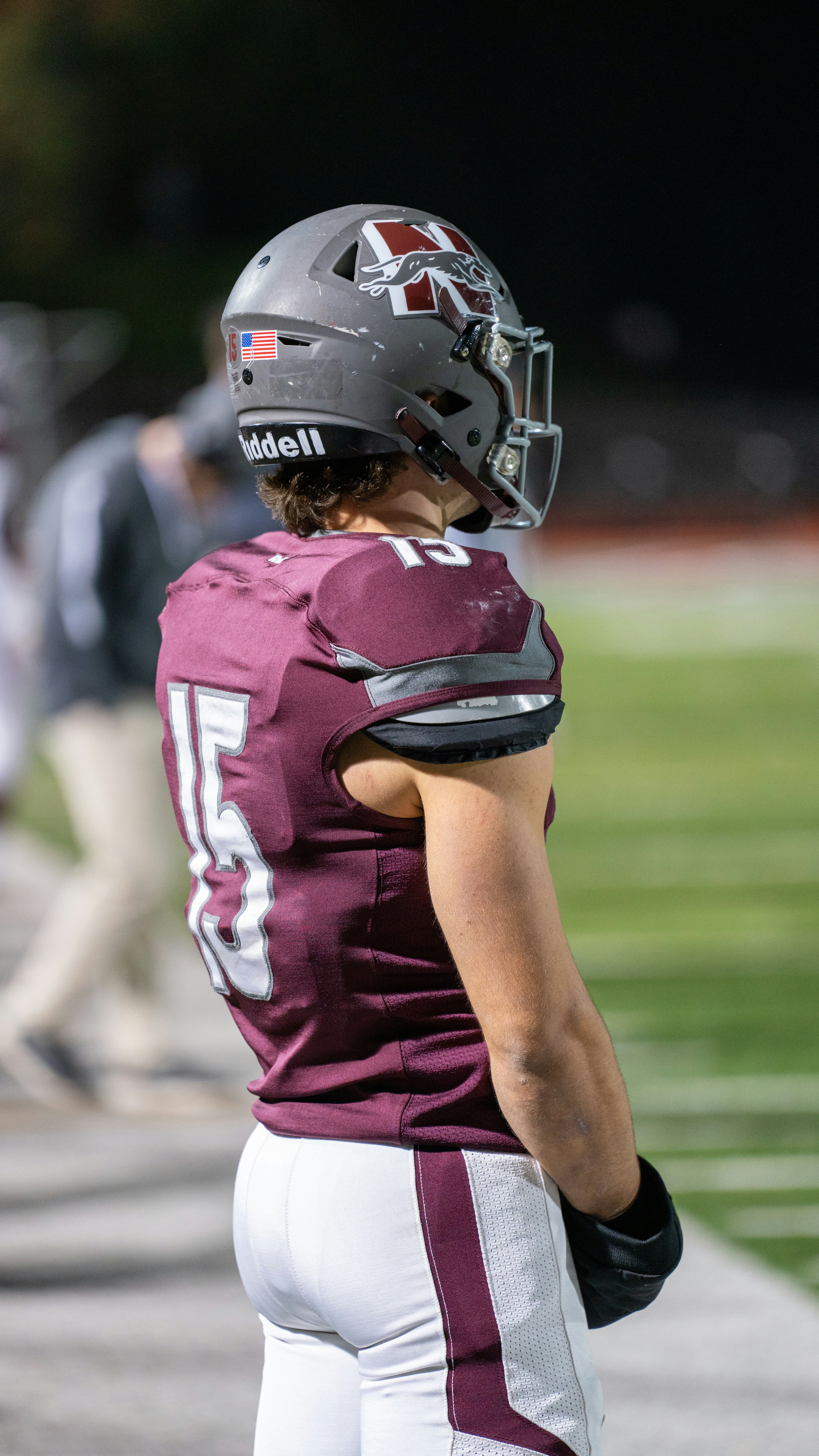 A man in a football uniform standing on a field