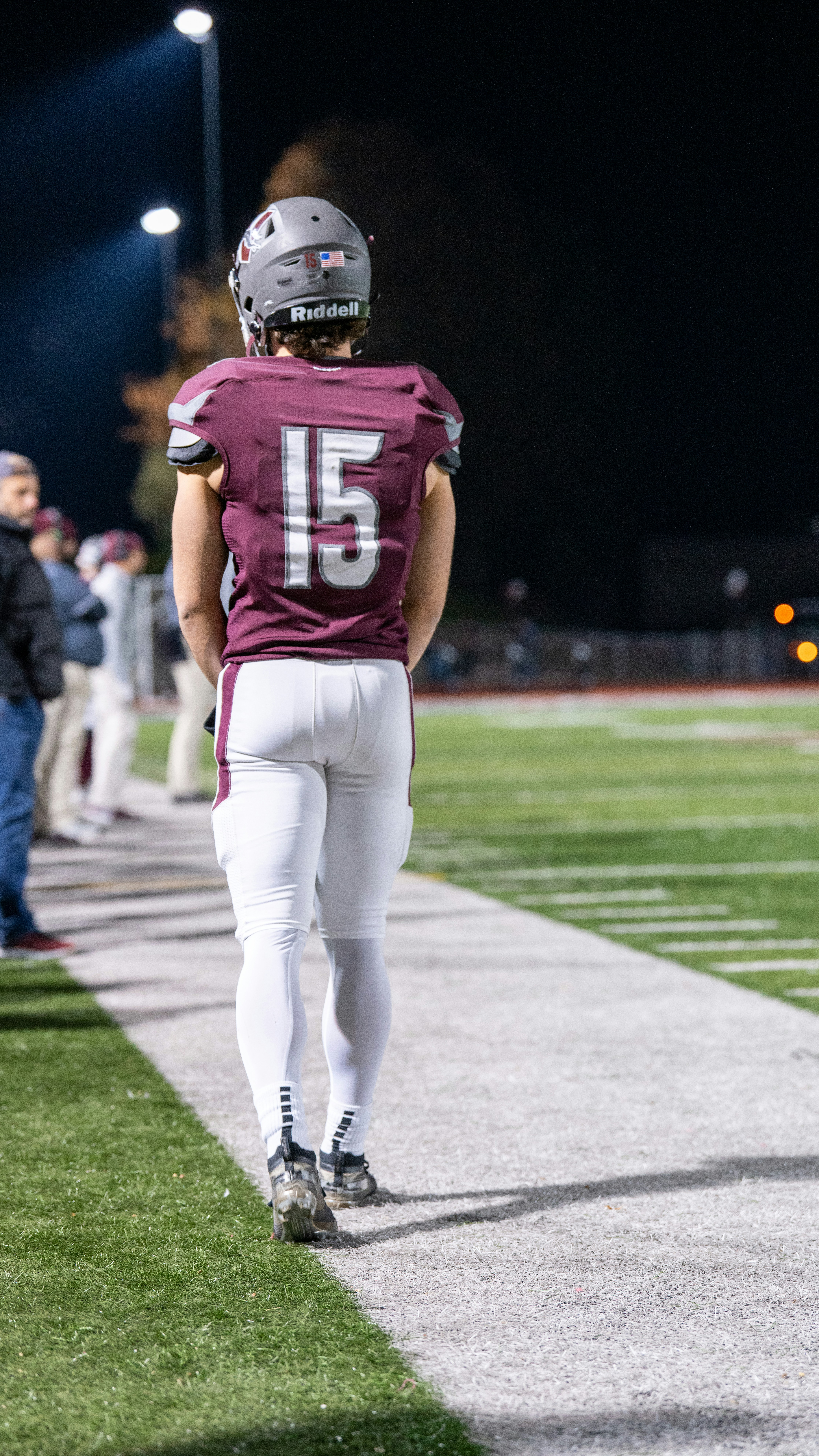 A football player is walking down the field