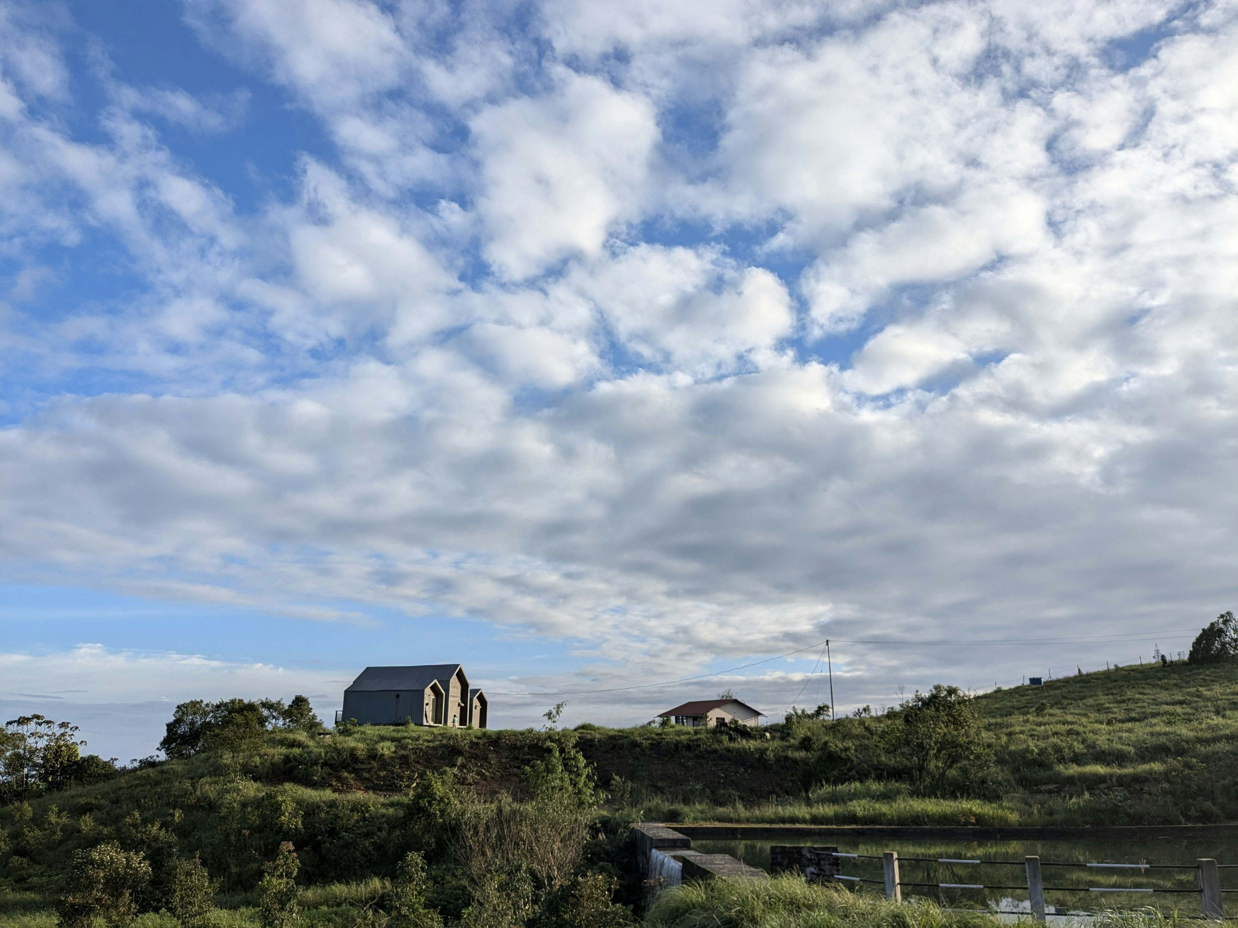A house on a hill overlooking a body of water