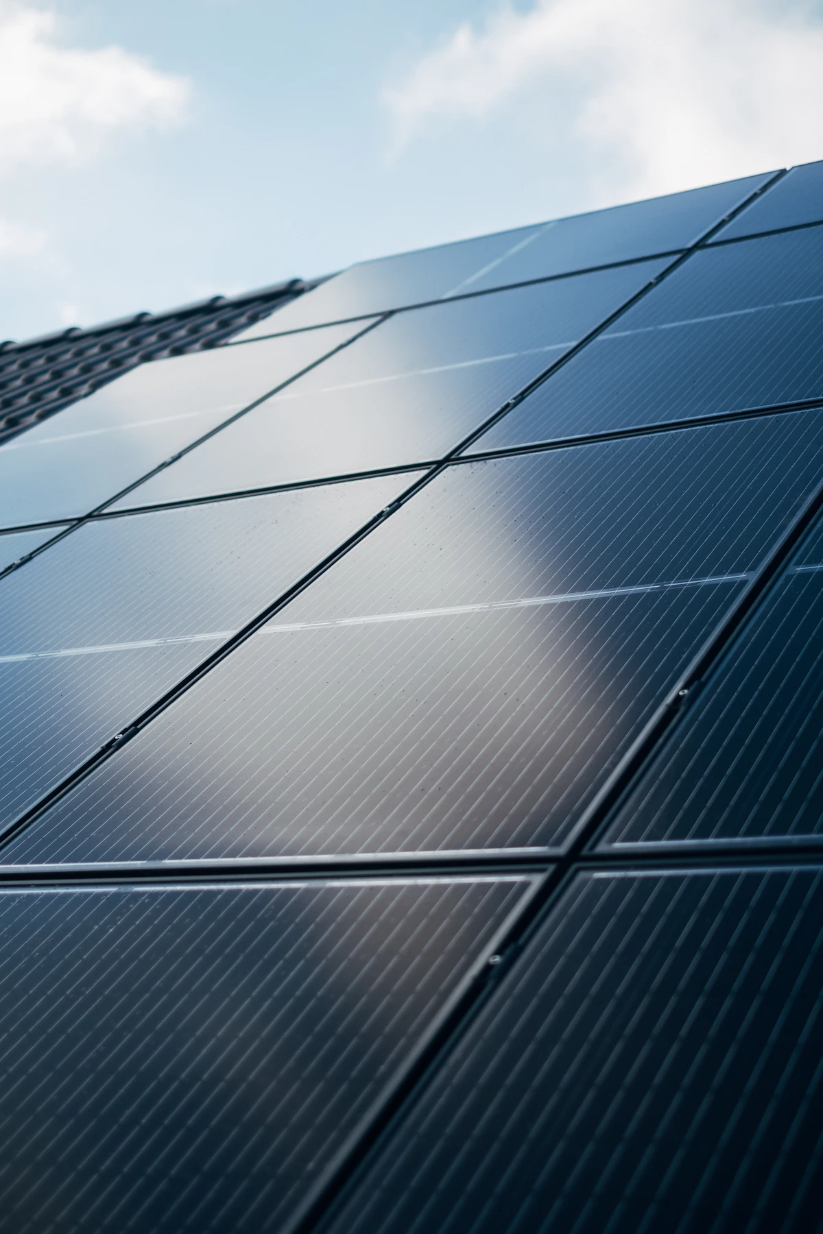 Close-up of dark monocrystalline solar panels on a roof