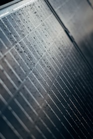 A close up of a tiled wall with water droplets
