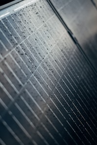 A close up of a tiled wall with water droplets