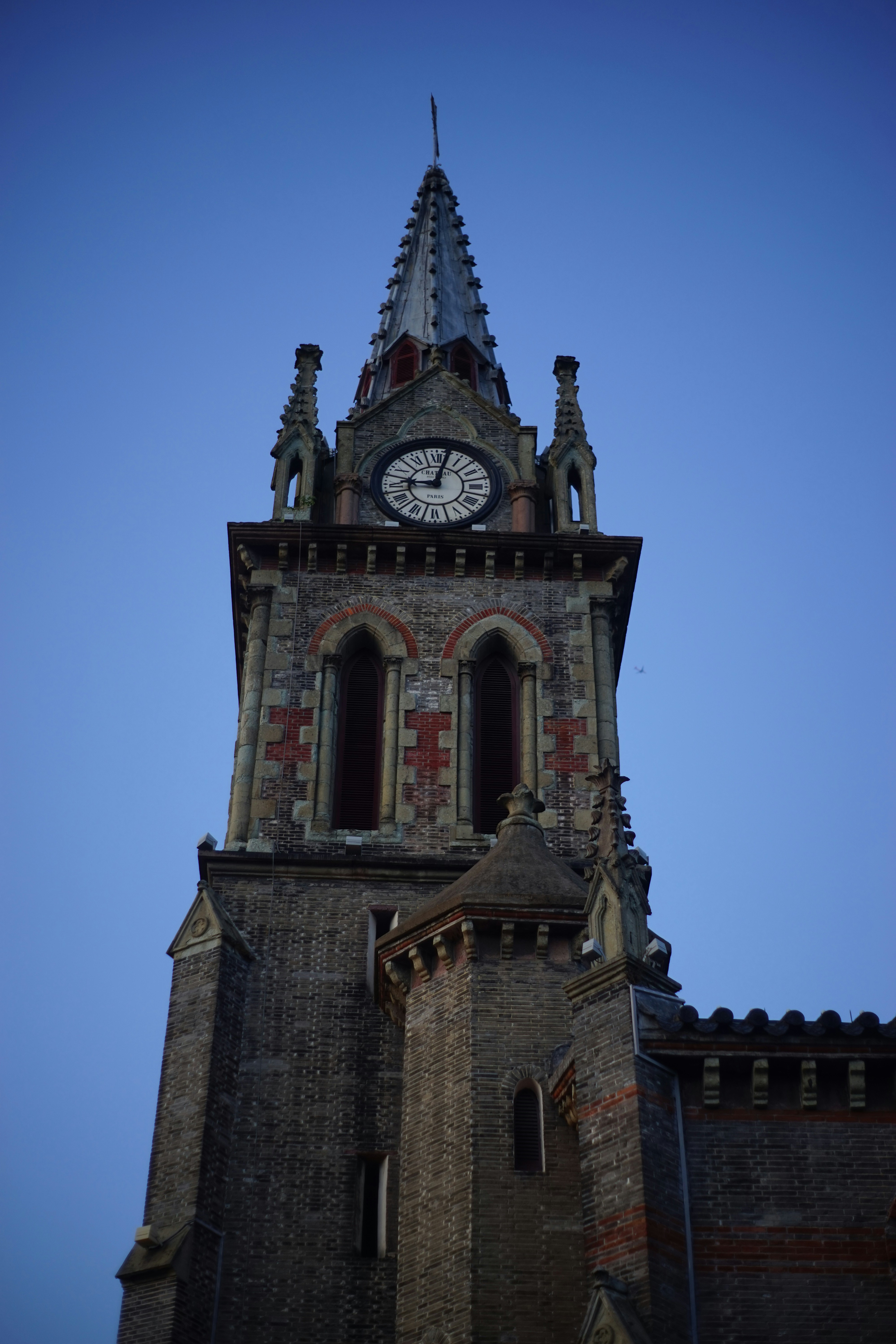 A tall tower with a clock on the top of it