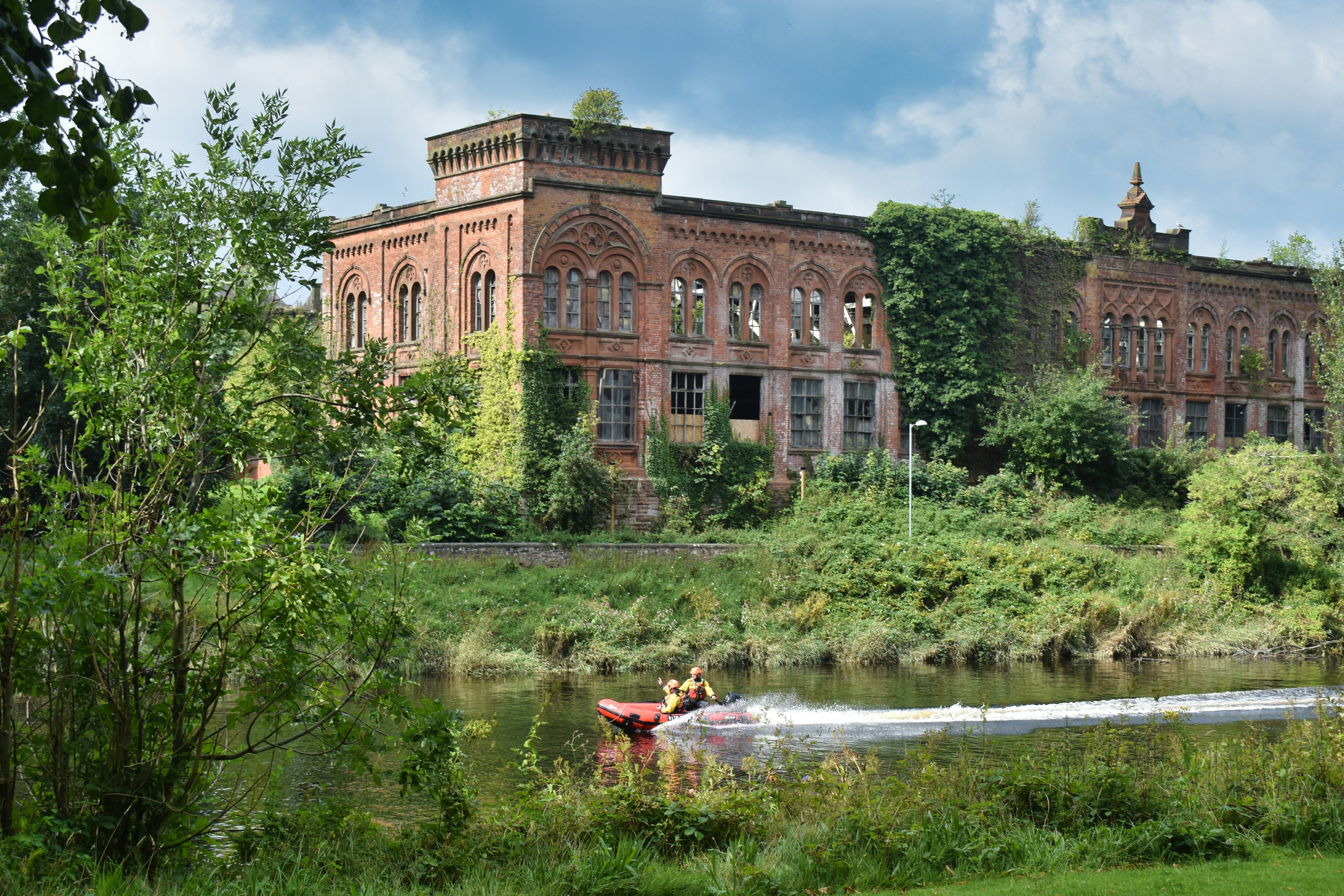 An old building sitting on top of a lush green field