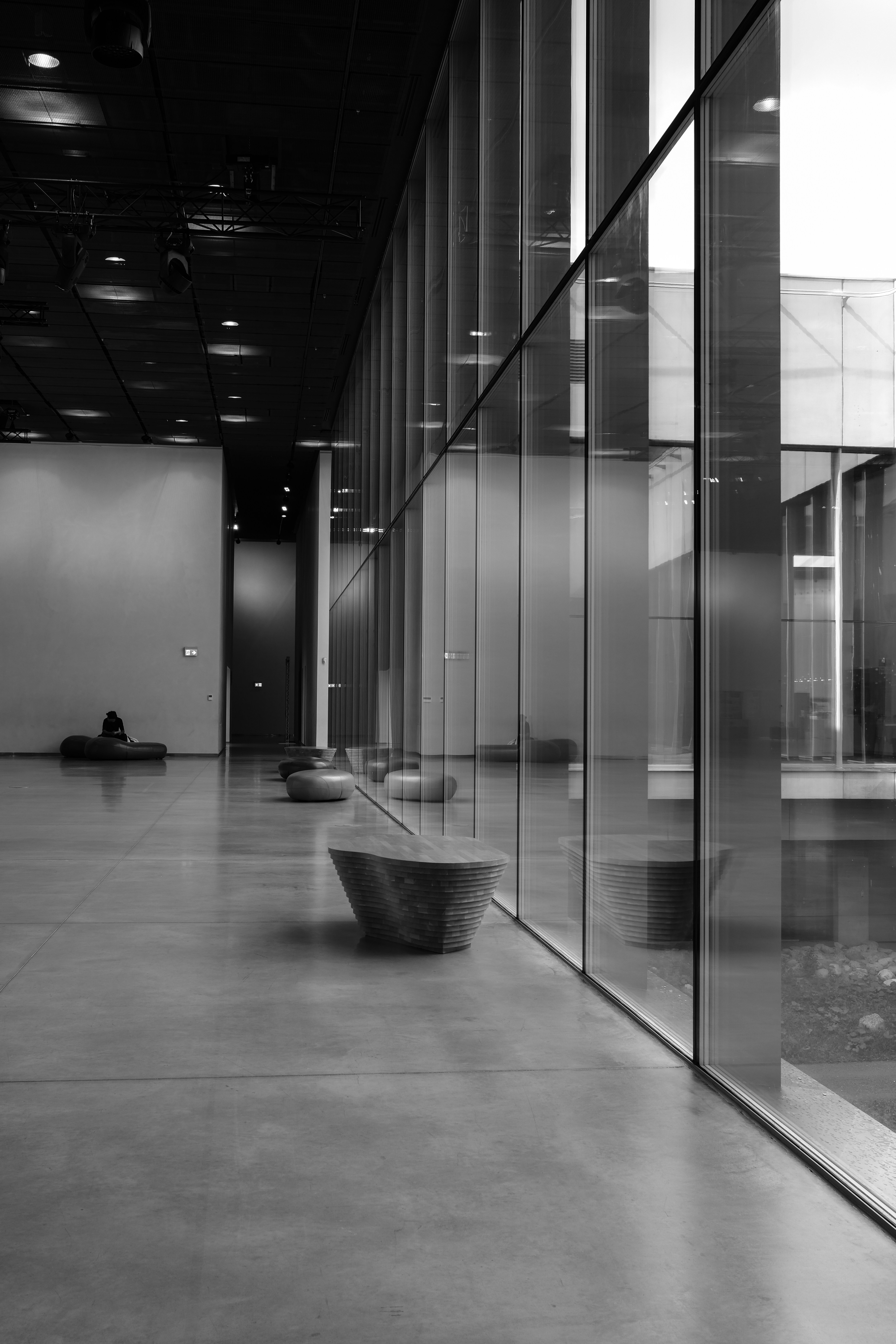 A black and white photo of a room with glass walls