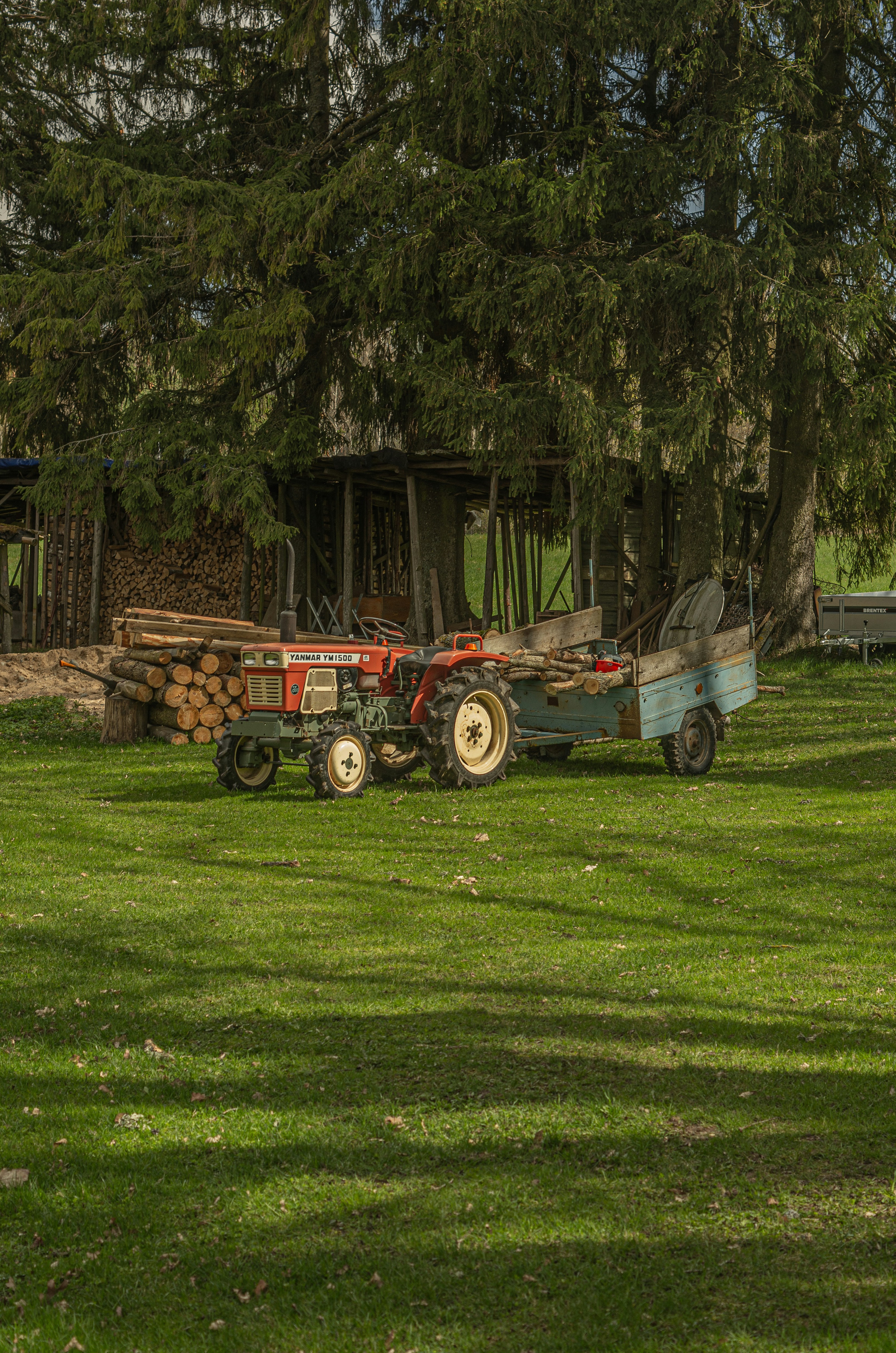 A tractor parked in a field next to a house
