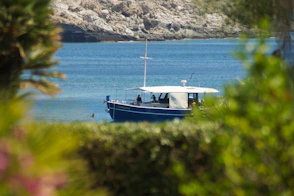 A blue and white boat floating on top of a body of water