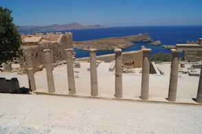 A group of pillars sitting on top of a sandy beach