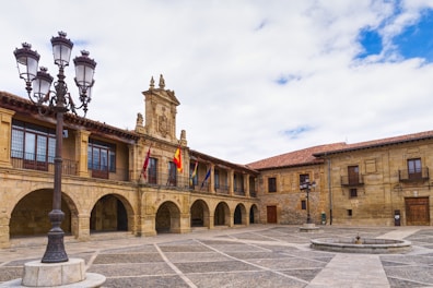 A large courtyard with a clock tower in the background