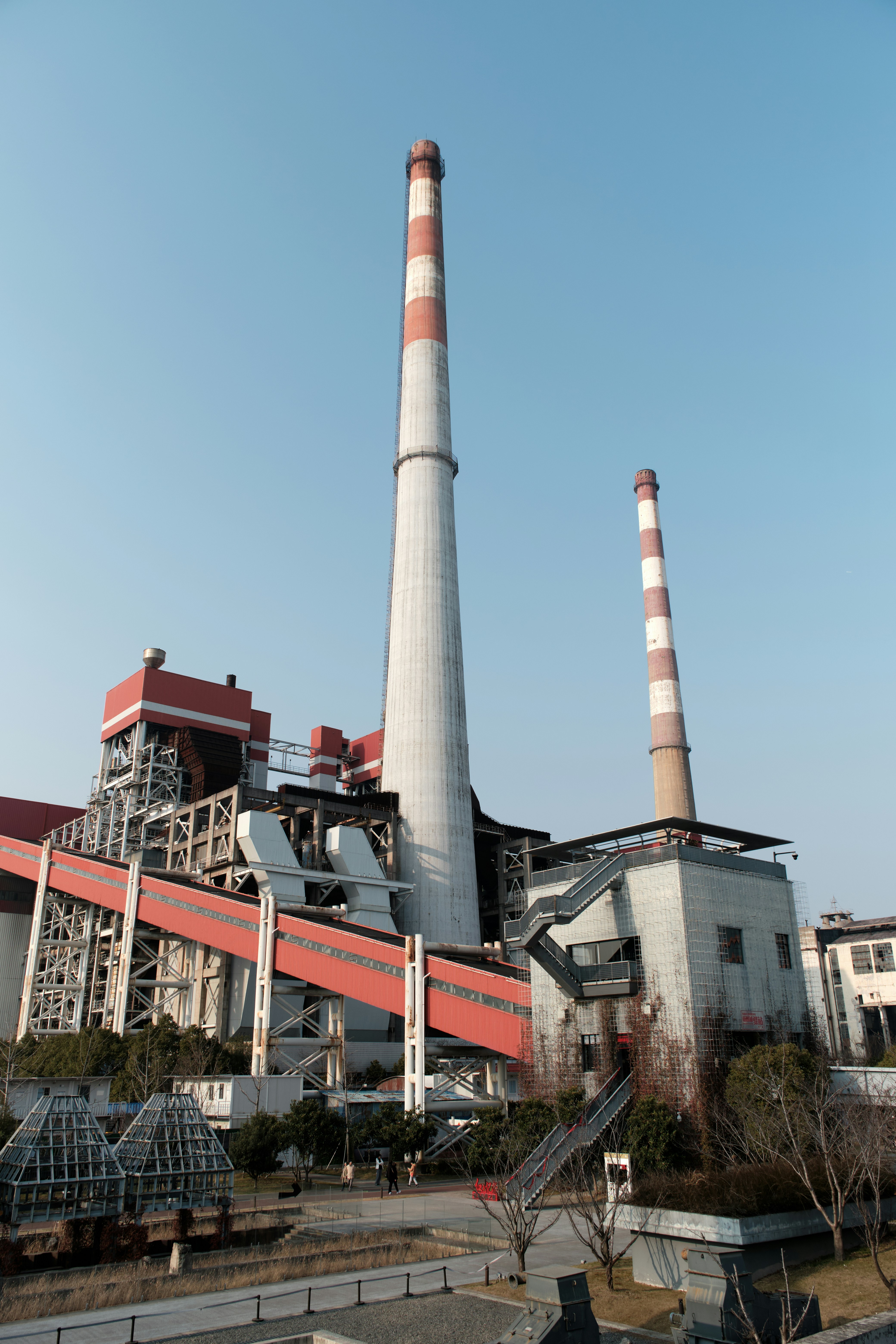 Un edificio de fábrica con una chimenea roja y blanca