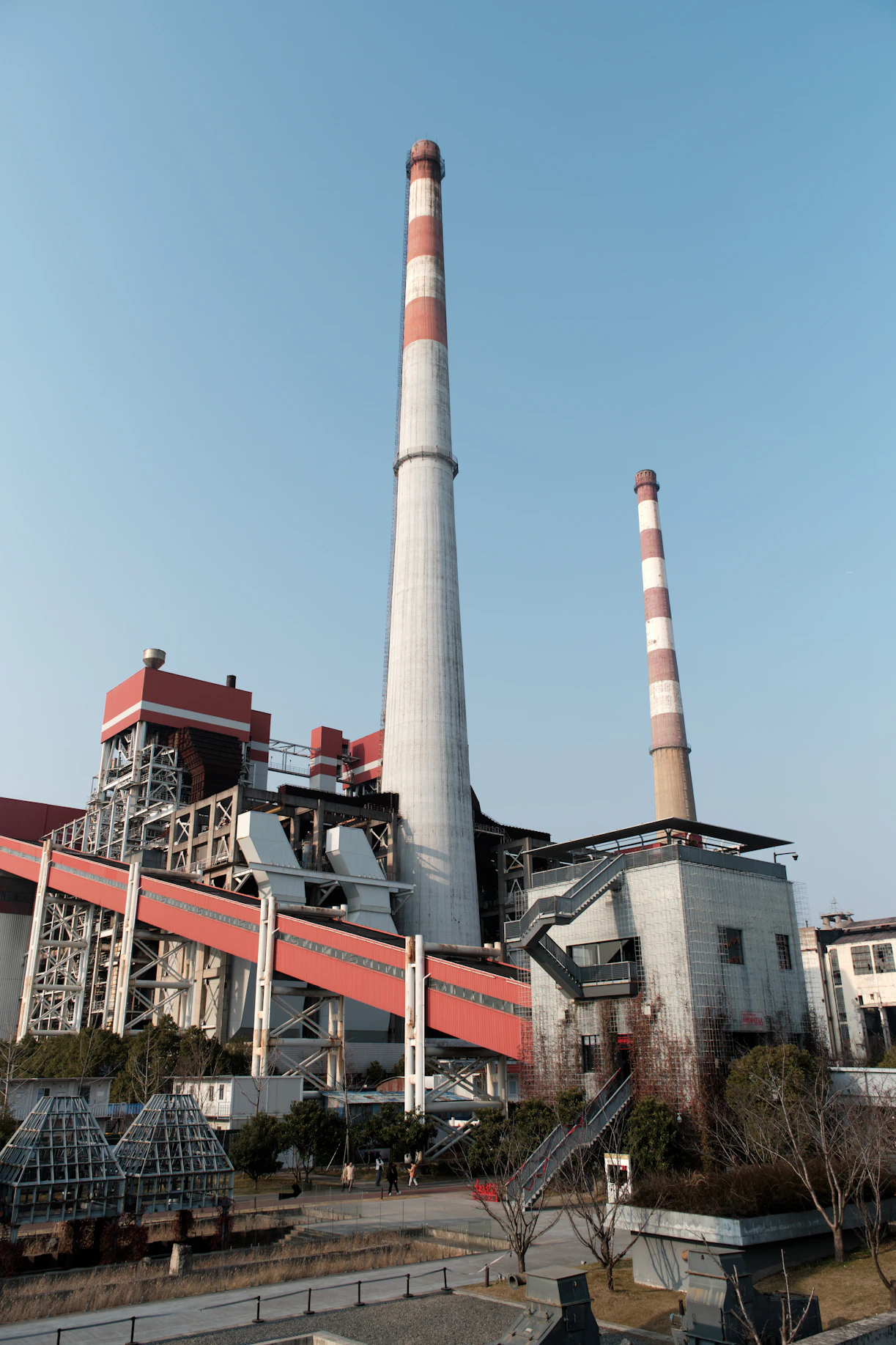 A factory building with a red and white chimney