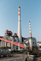 A factory building with a red and white chimney