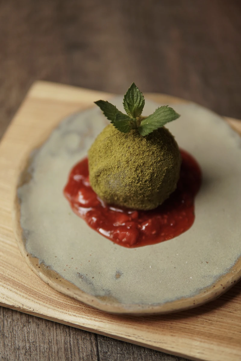 A small dessert with a leaf on top of it