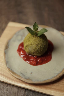 A small dessert with a leaf on top of it