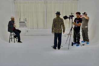 A group of people standing around a white room
