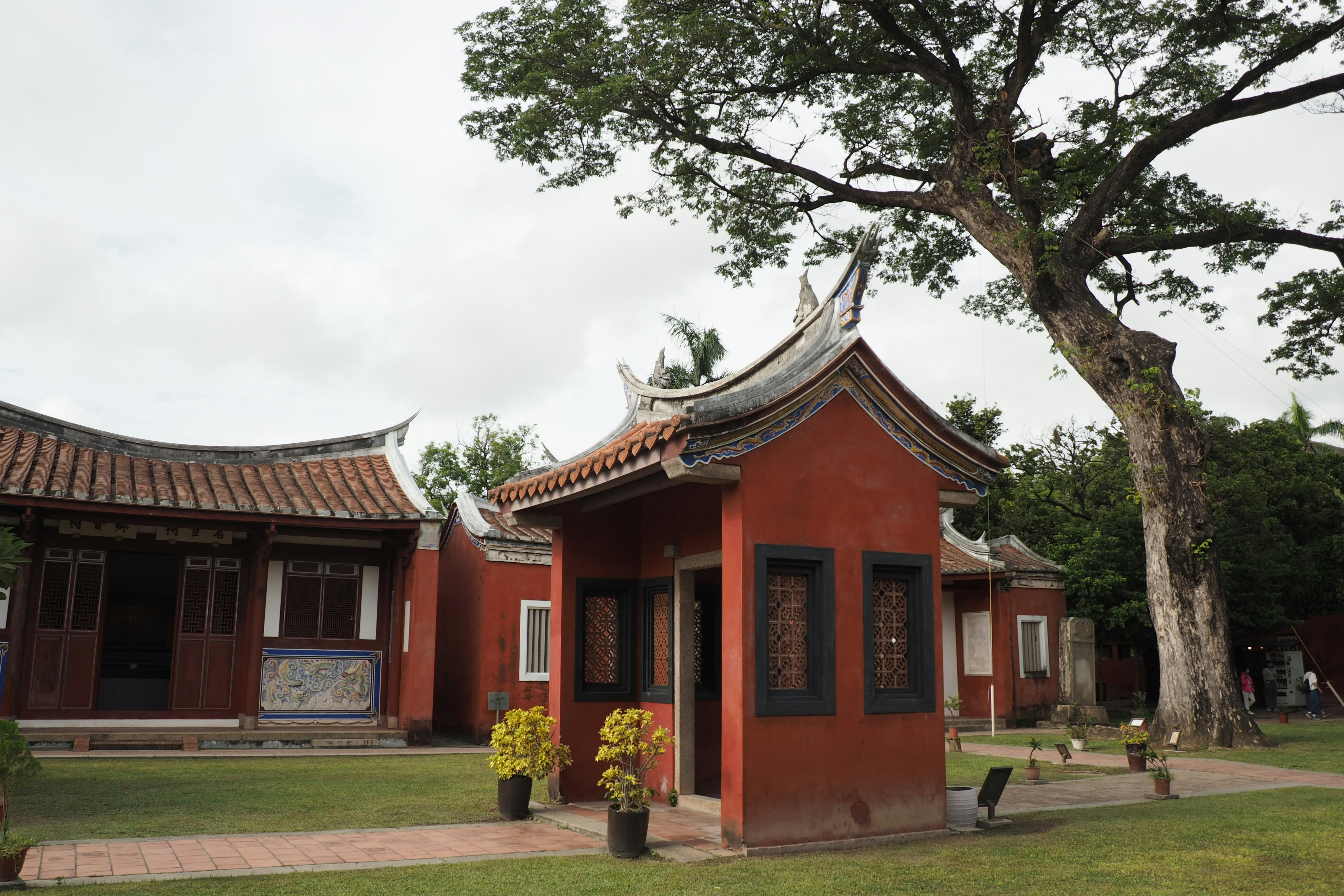 A red building with a tree in front of it