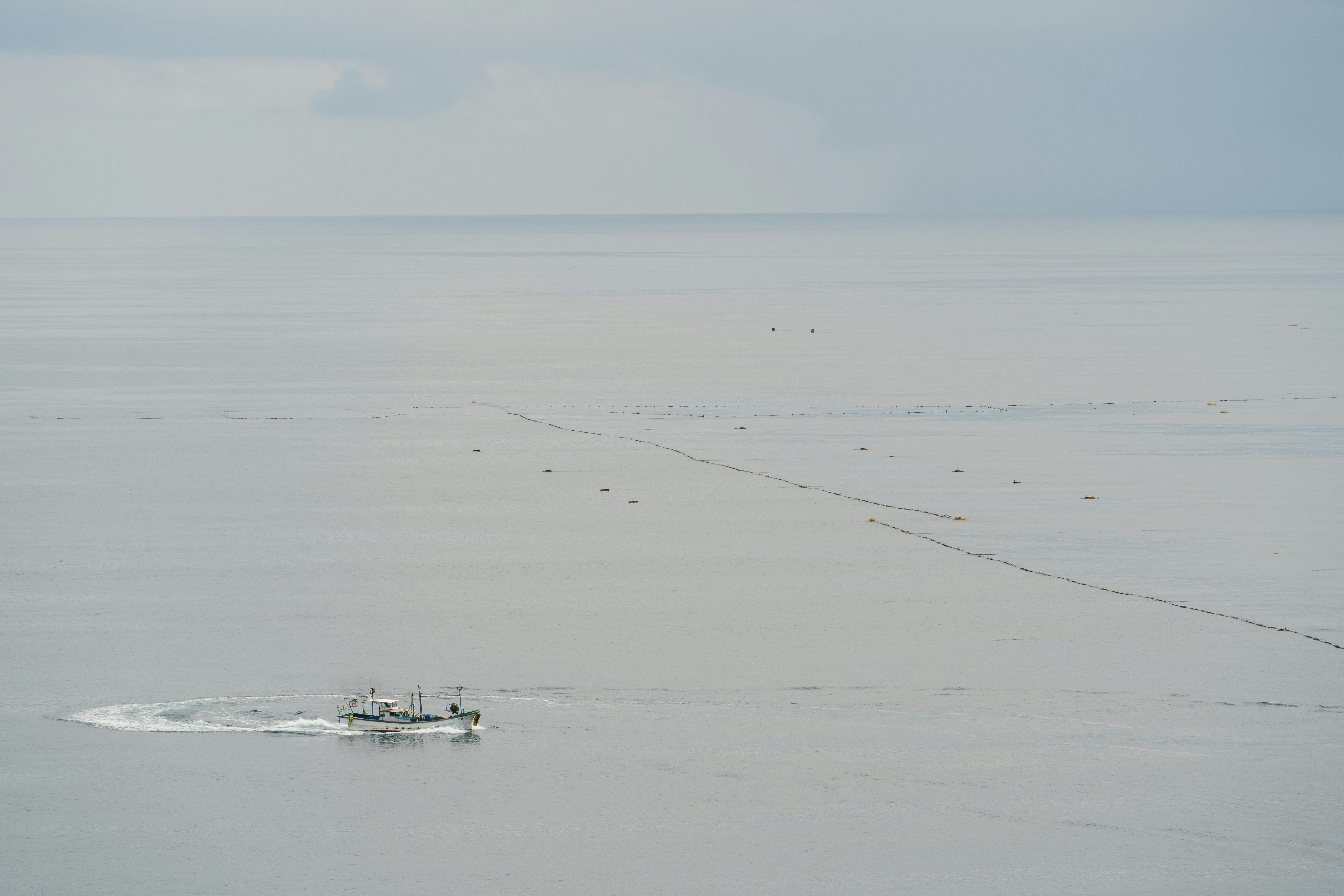 A boat in the middle of a large body of water