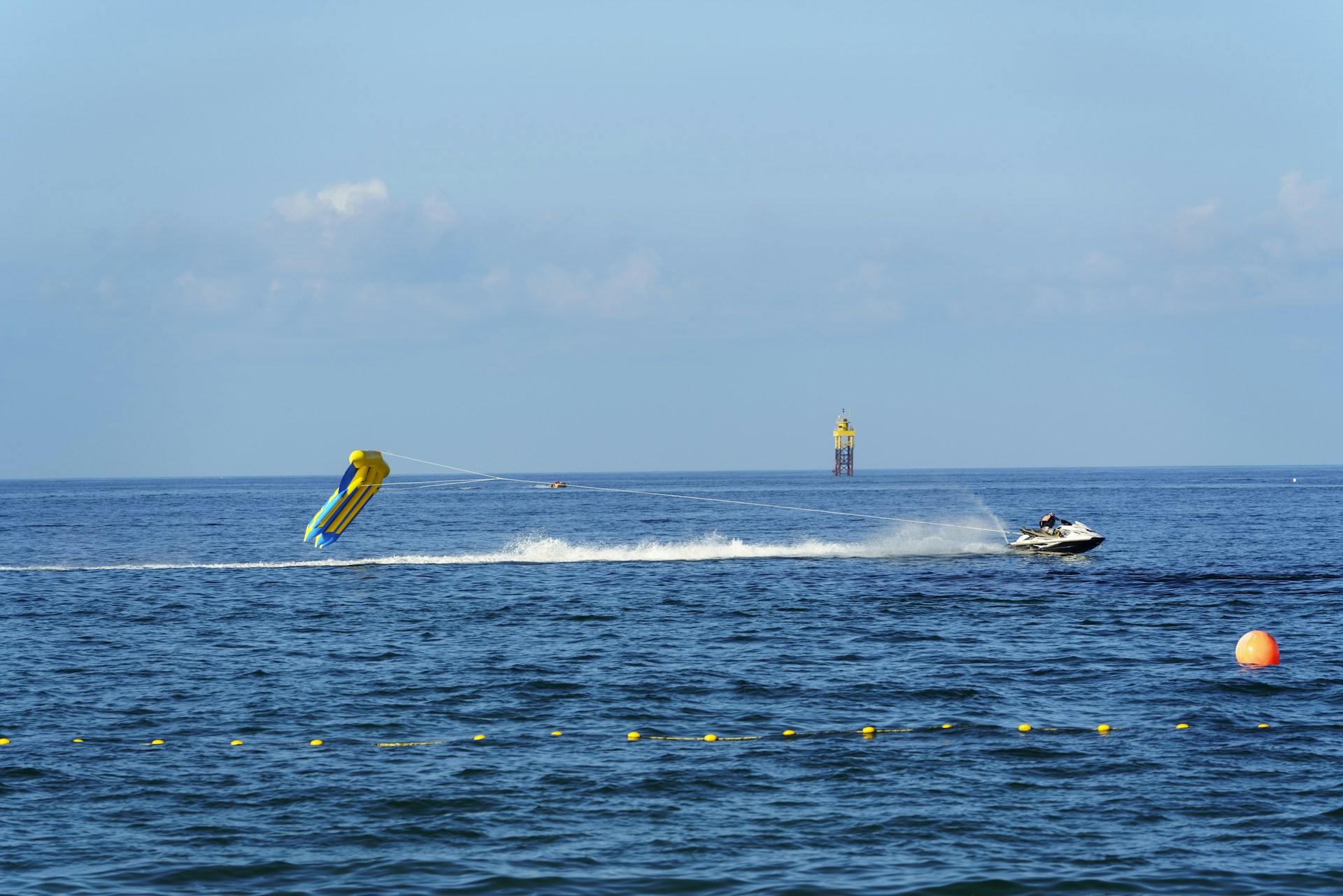 A person on a water ski being pulled by a boat