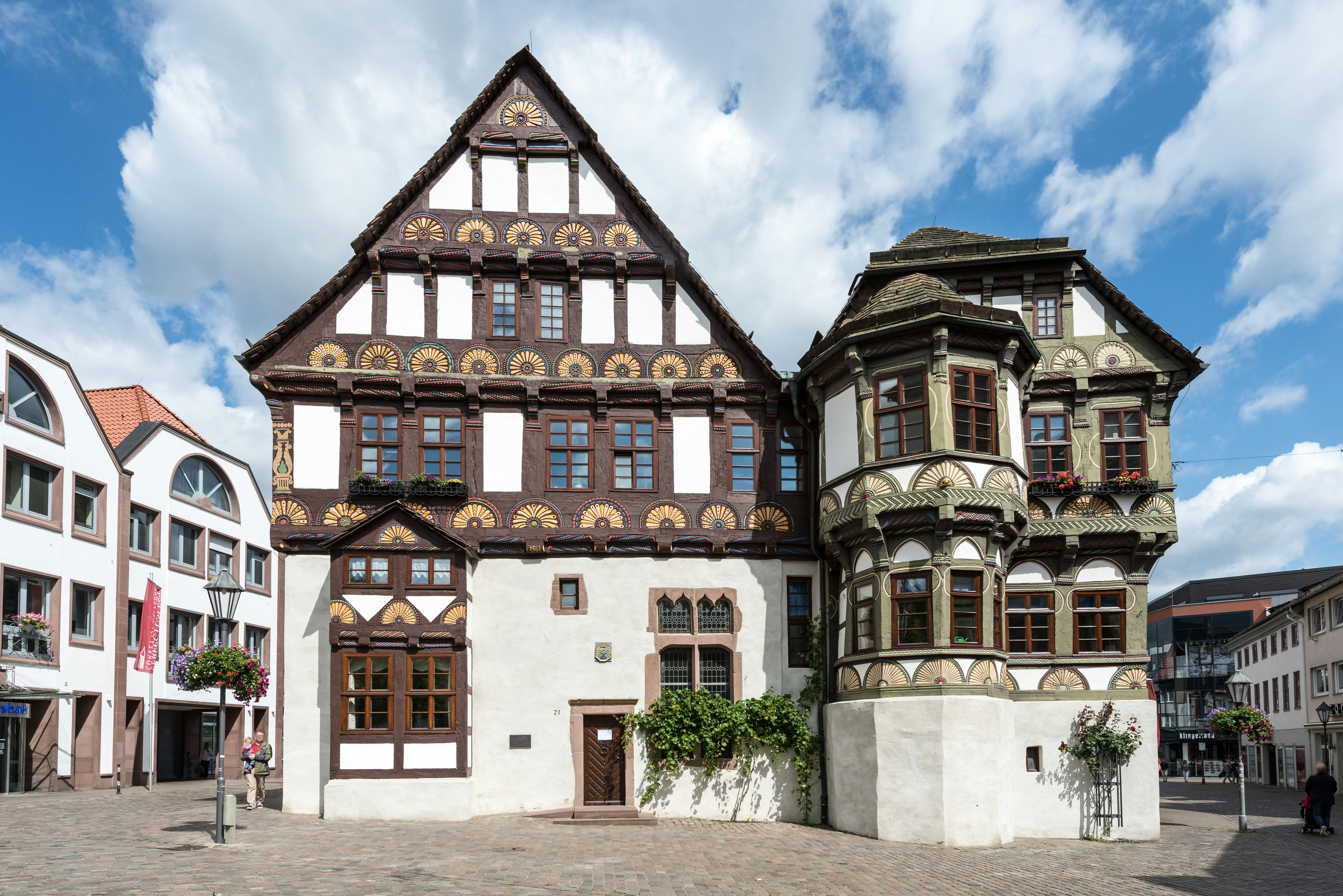 A large white and brown building with lots of windows