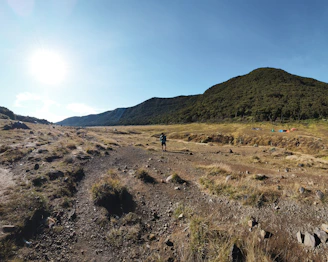 A man riding a bike down a dirt road