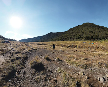 A man riding a bike down a dirt road