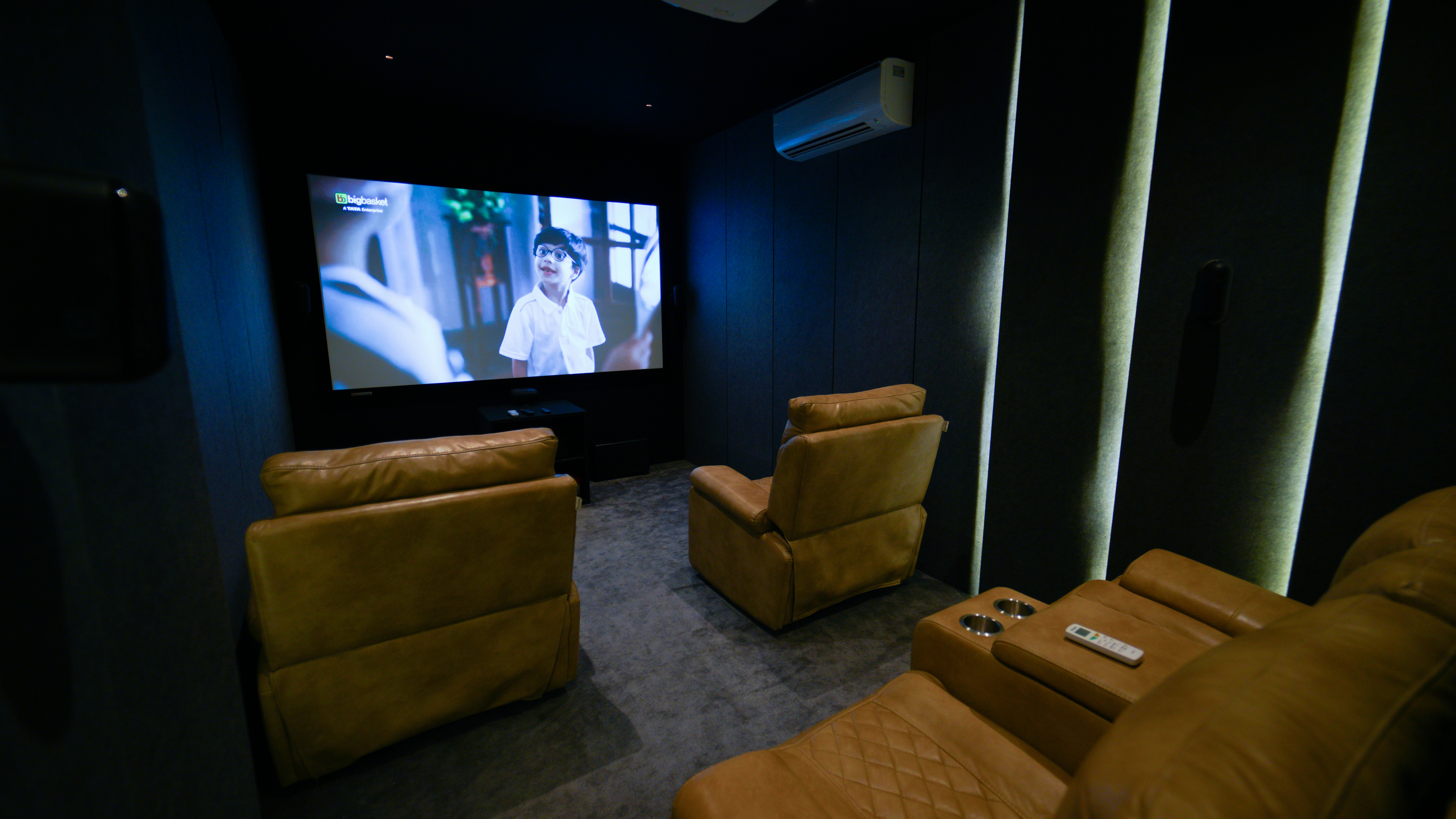 A home theater with two recliners and a flat screen TV