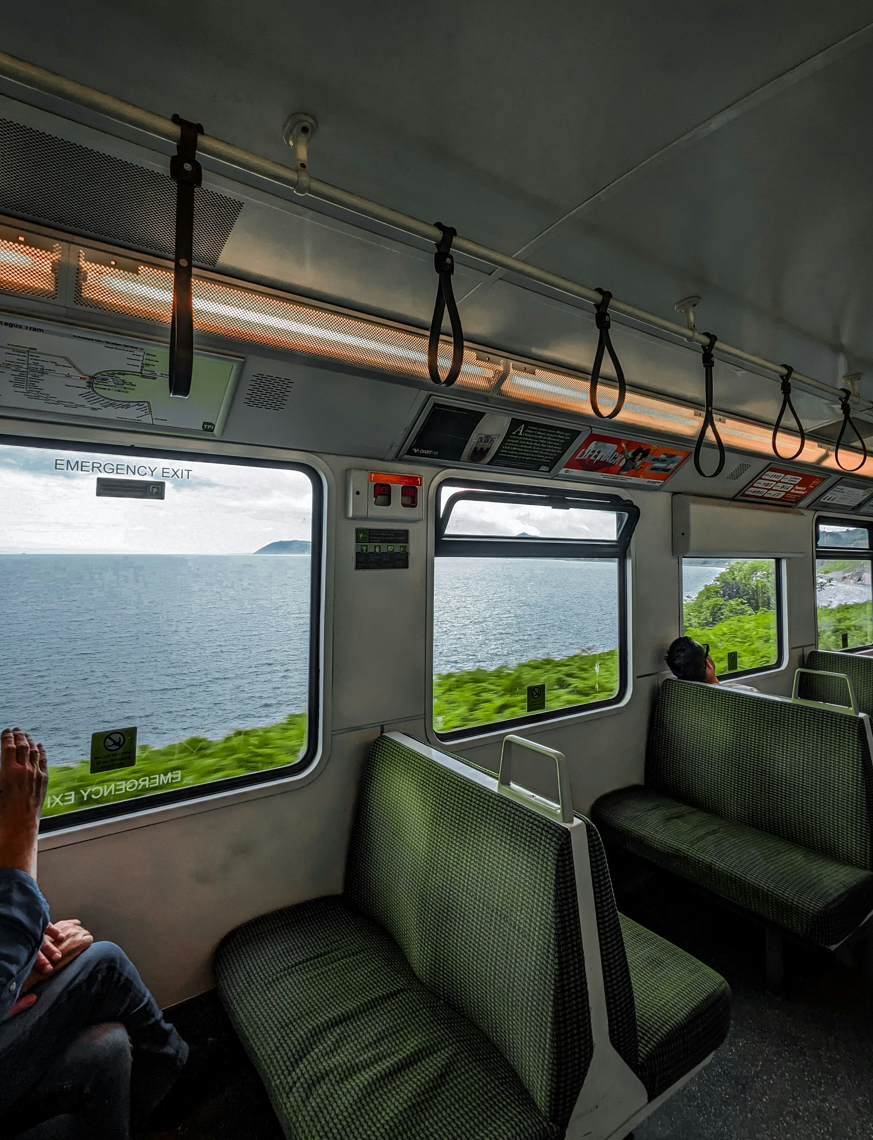 A man sitting on a train looking out the window