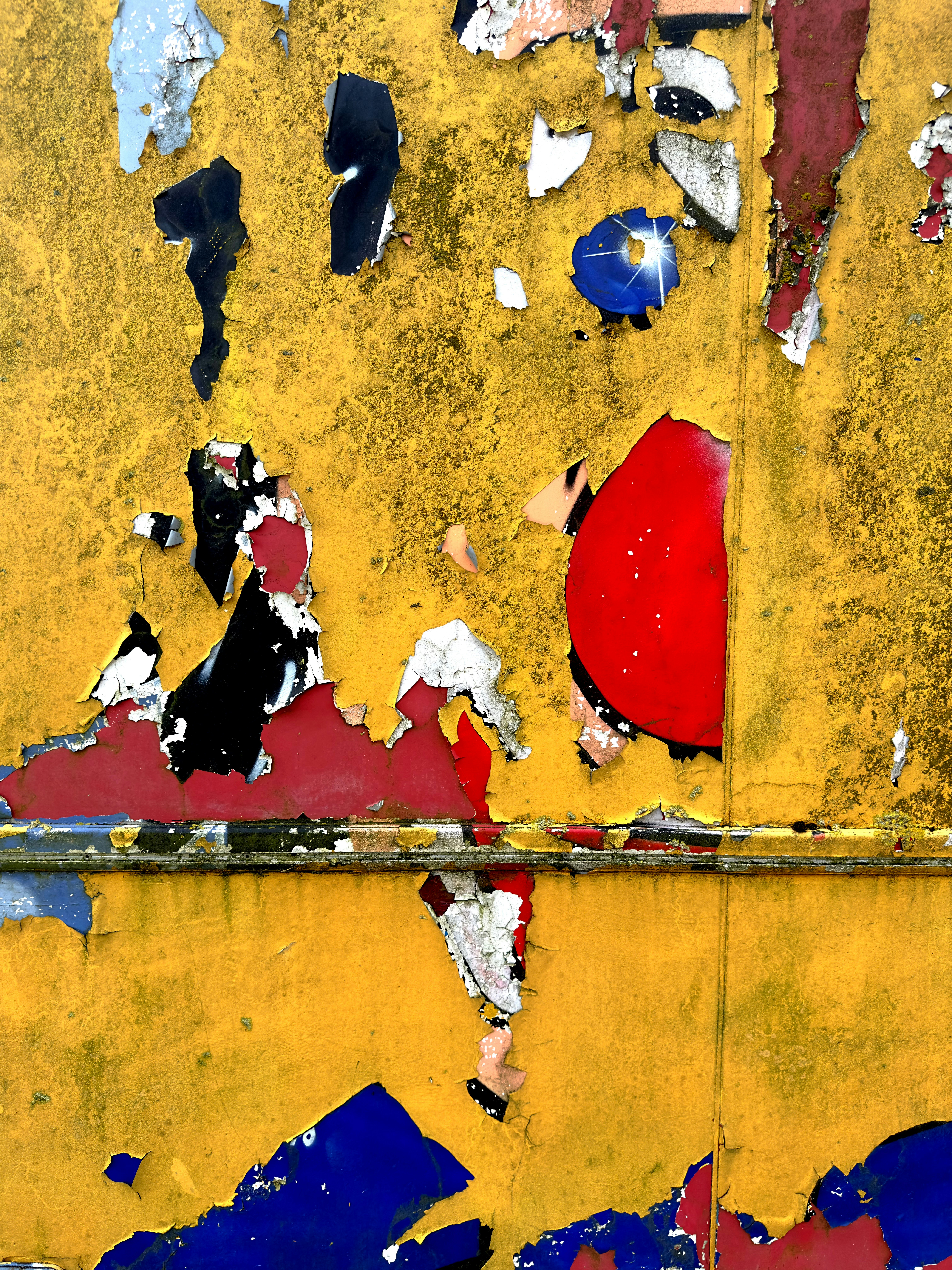 A close up of a wall with peeling paint
