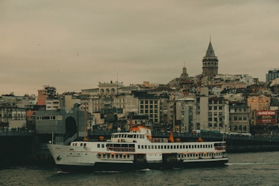 A large white boat floating on top of a river