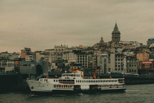 A large white boat floating on top of a river