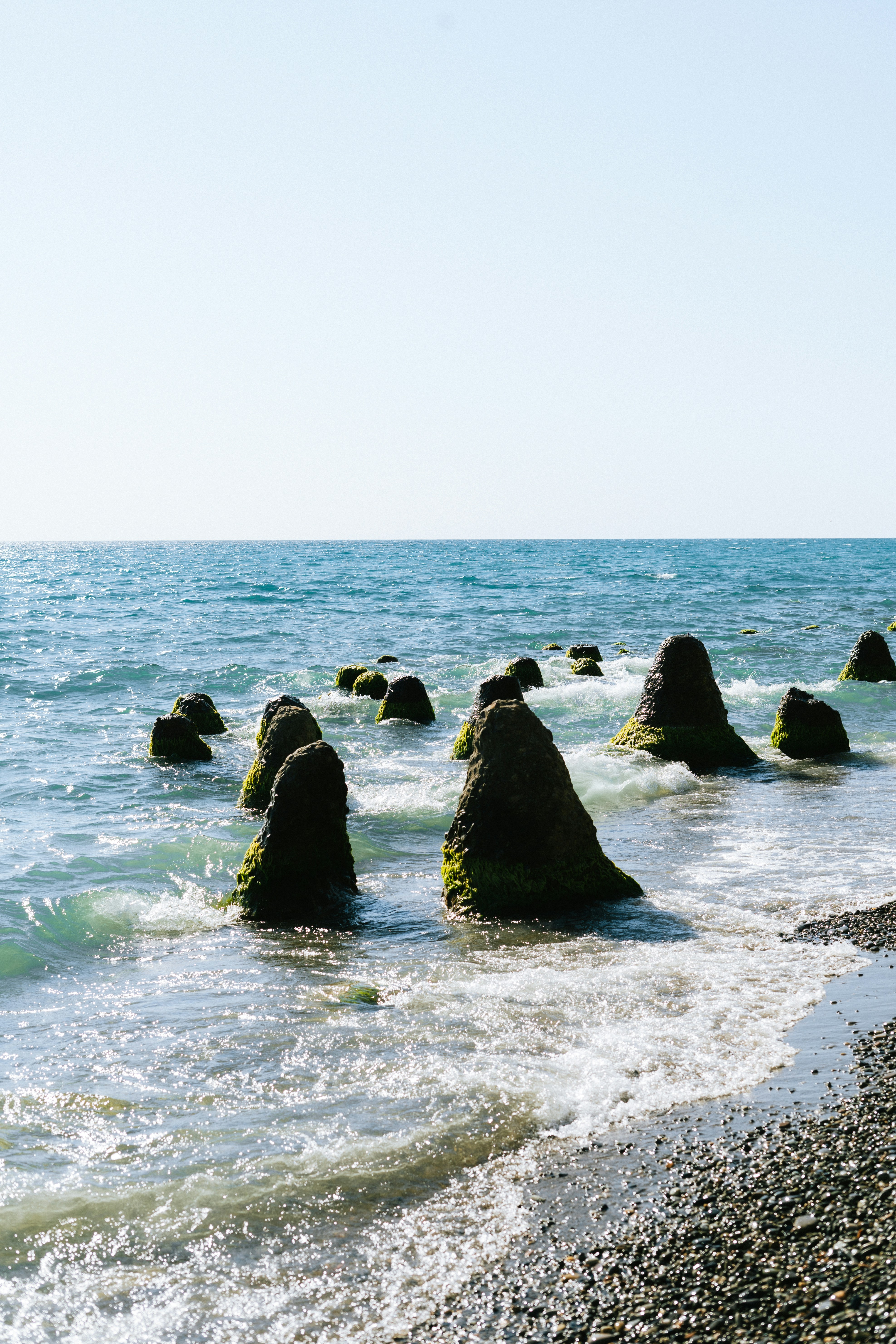 A group of rocks sitting on top of a beach