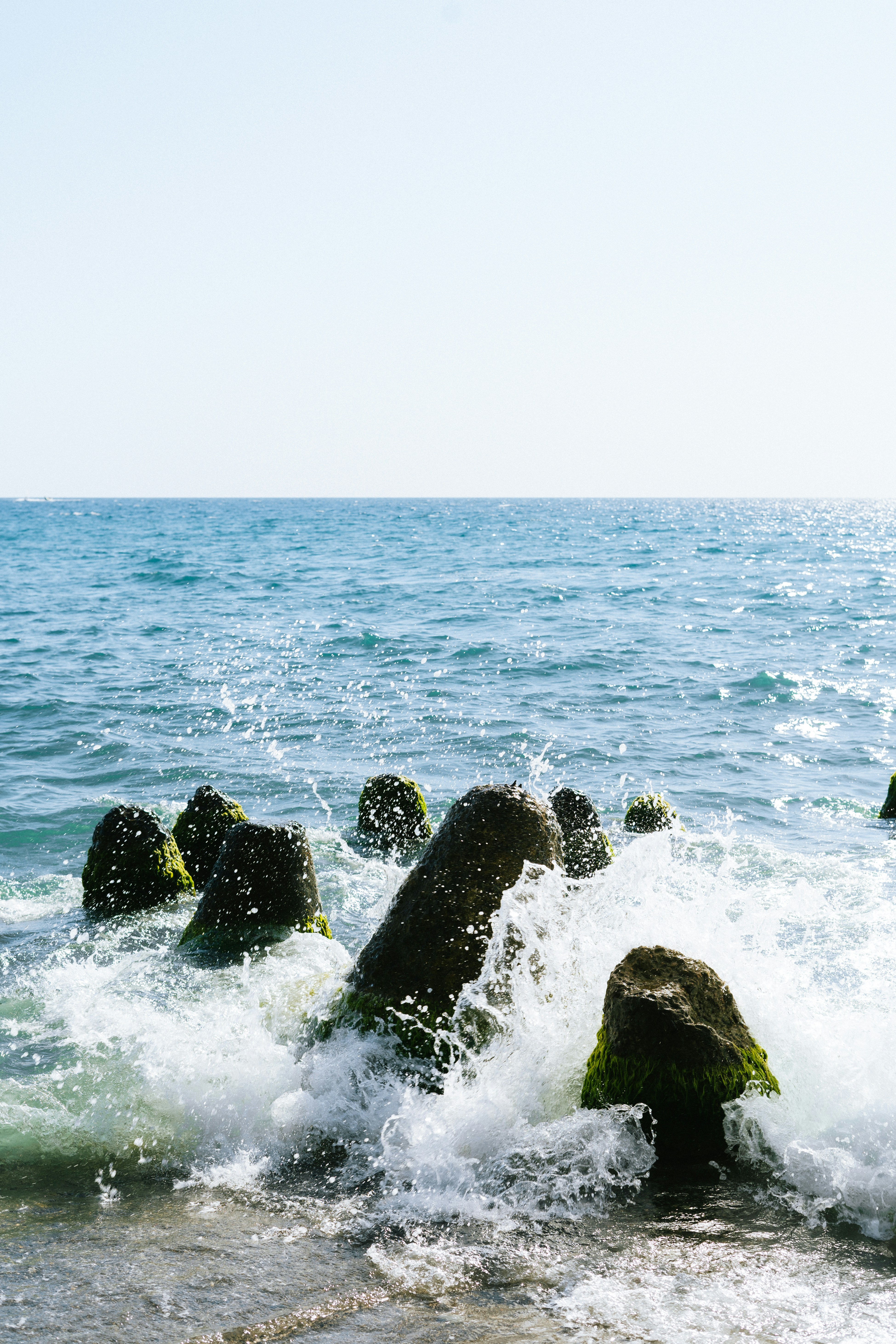 A group of rocks sticking out of the ocean
