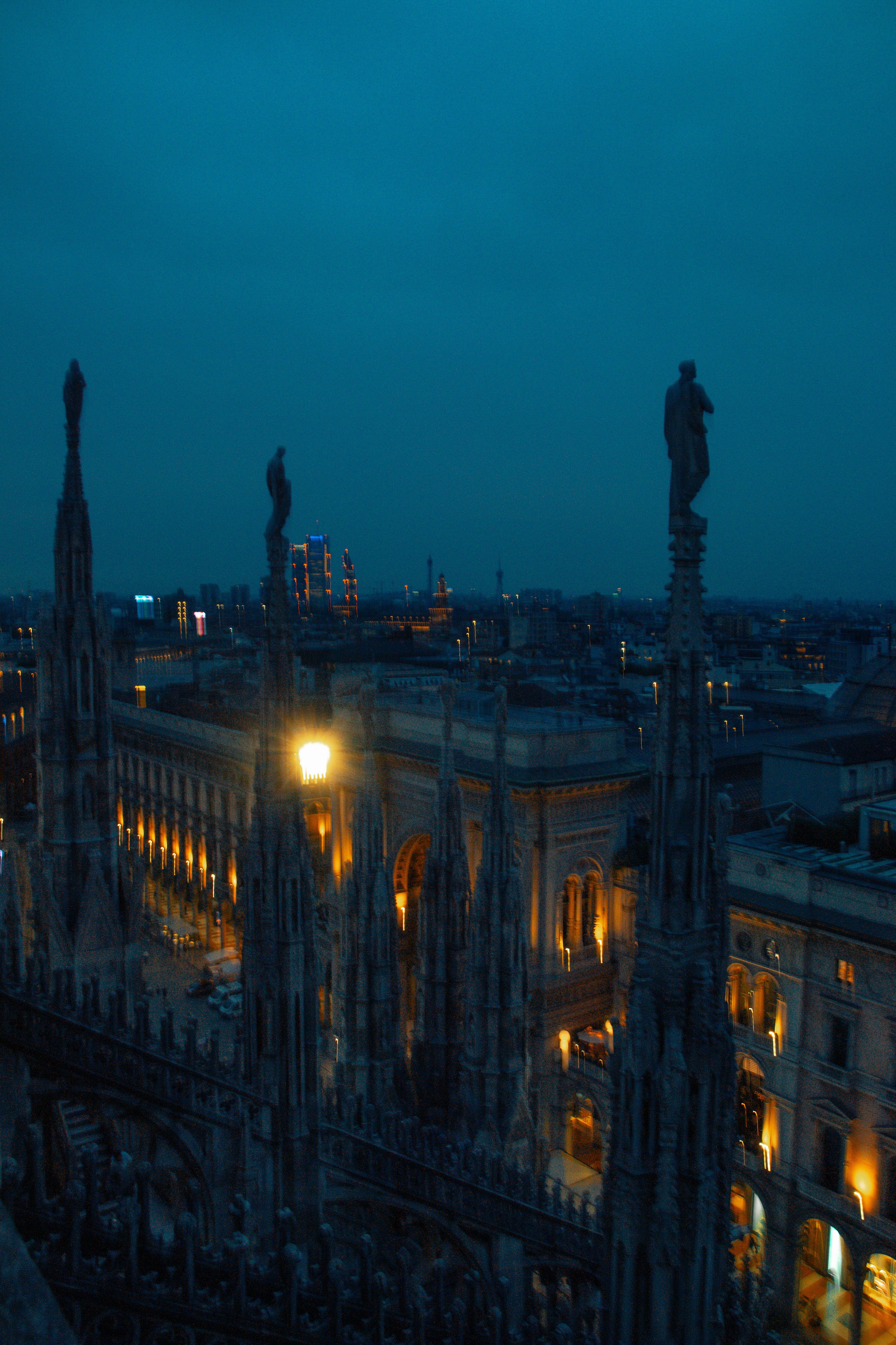 A view of a city at night from the top of a building photo – Free Art ...