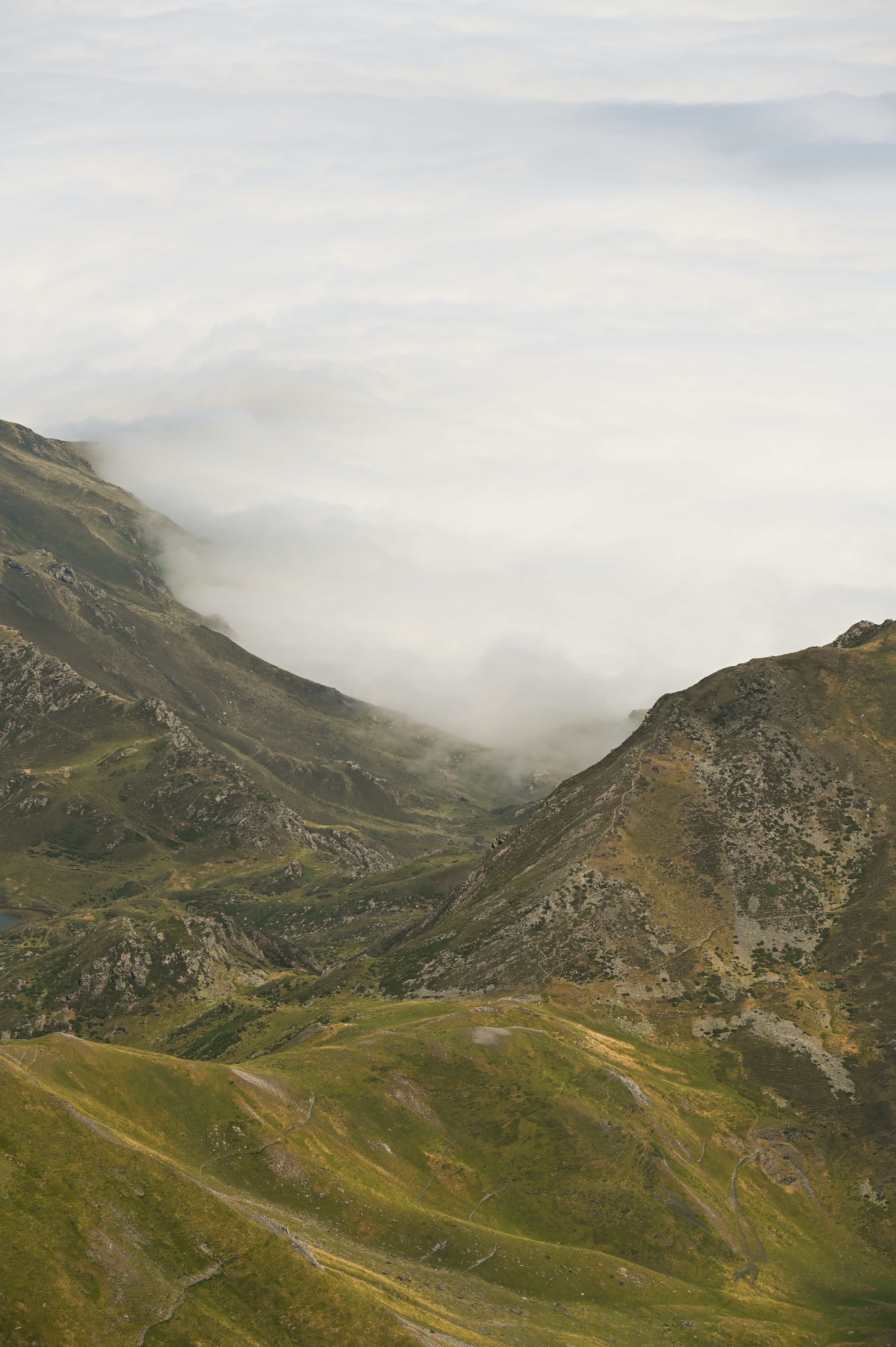 A view of a mountain range in the clouds