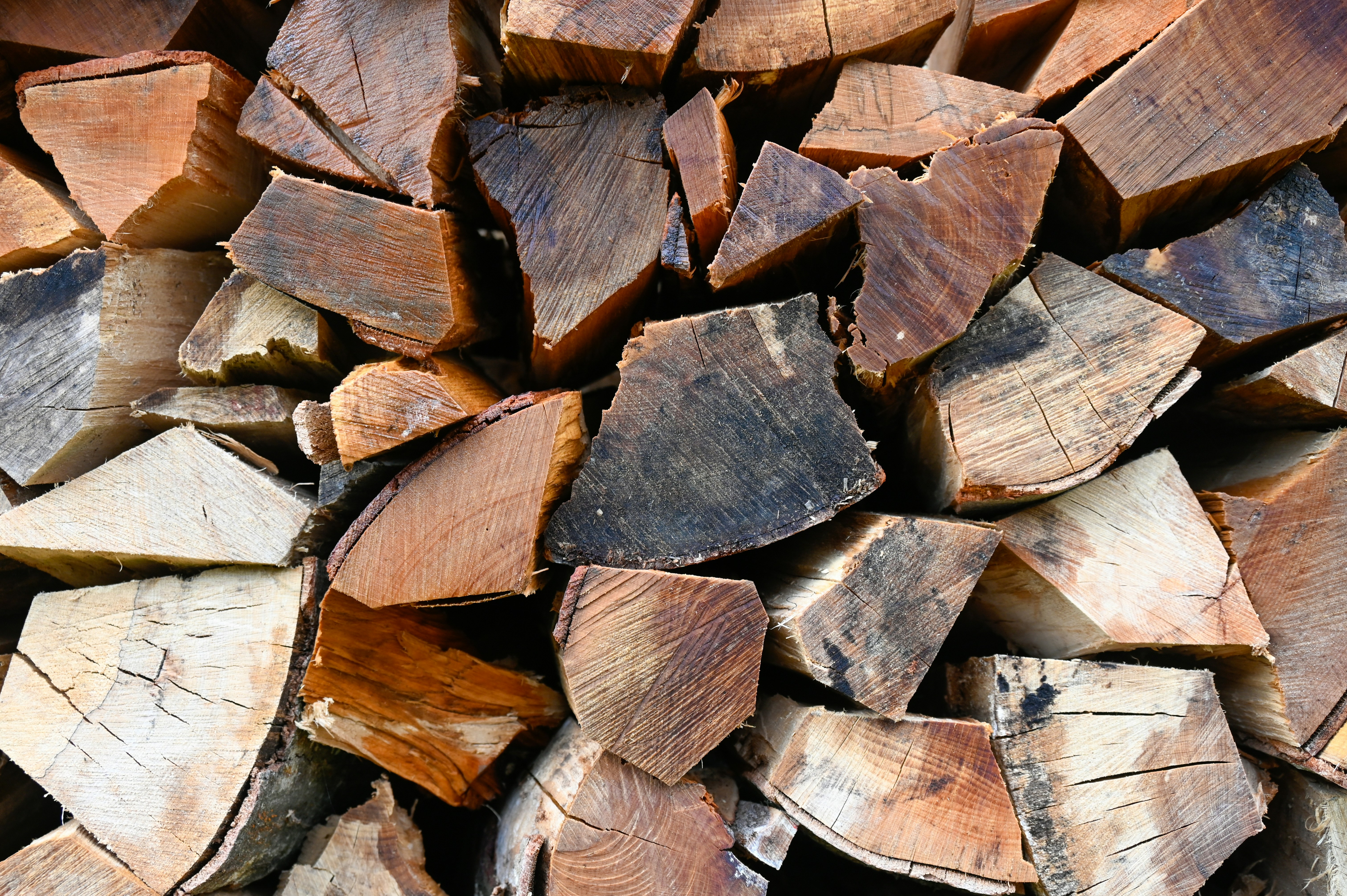 A pile of chopped wood sitting next to each other