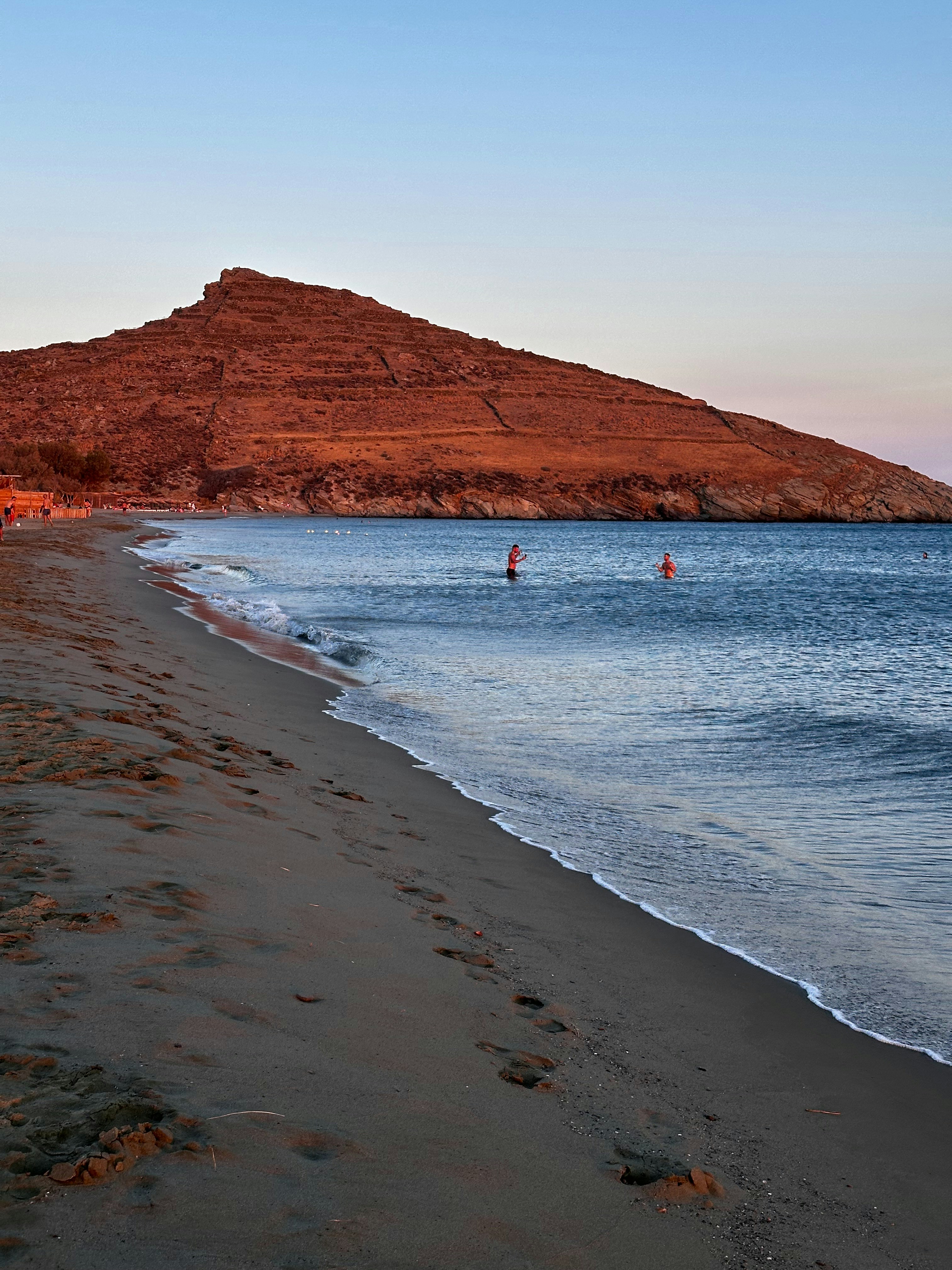 A beach with a mountain in the background