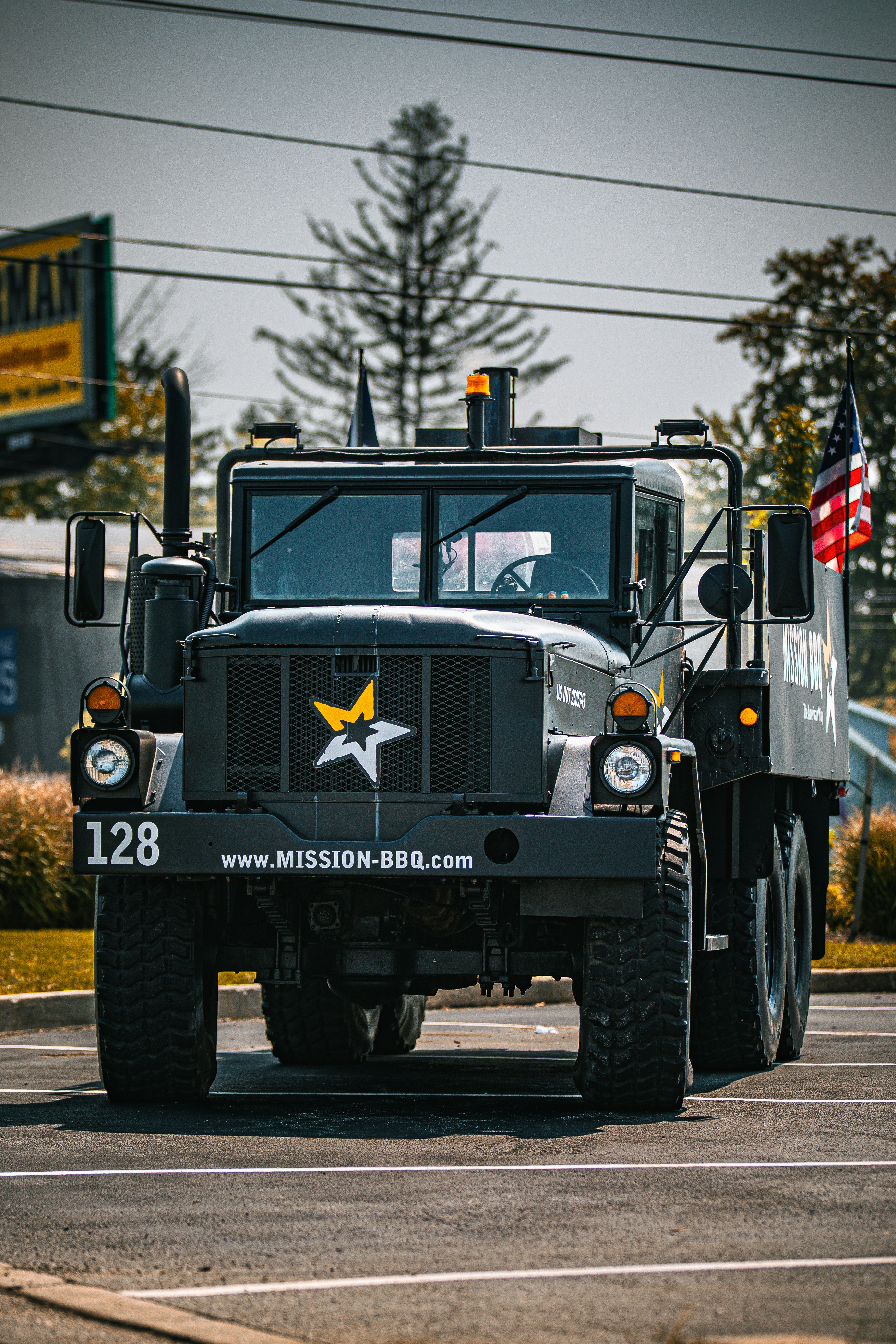 A large military truck driving down a street