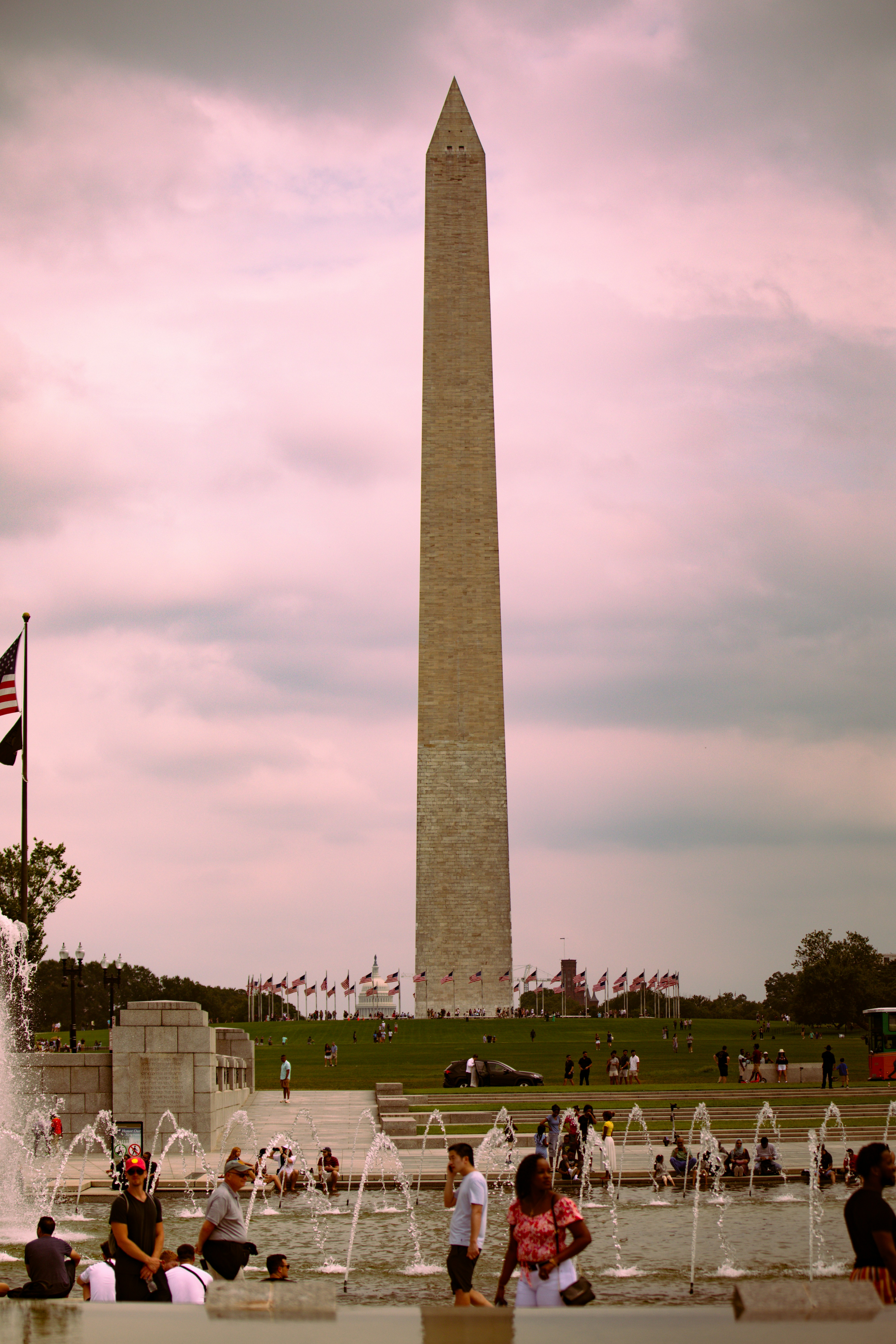 A group of people standing around a fountain