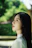 A woman with long black hair and a white shirt