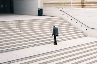 A man in a suit standing on some steps