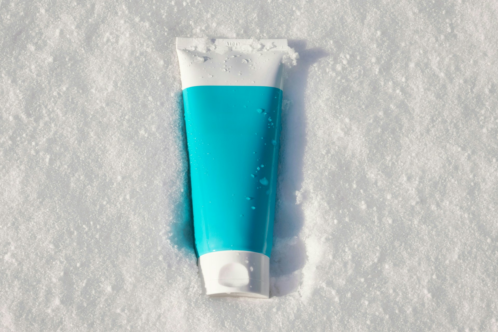A tube of toothpaste sitting in the snow