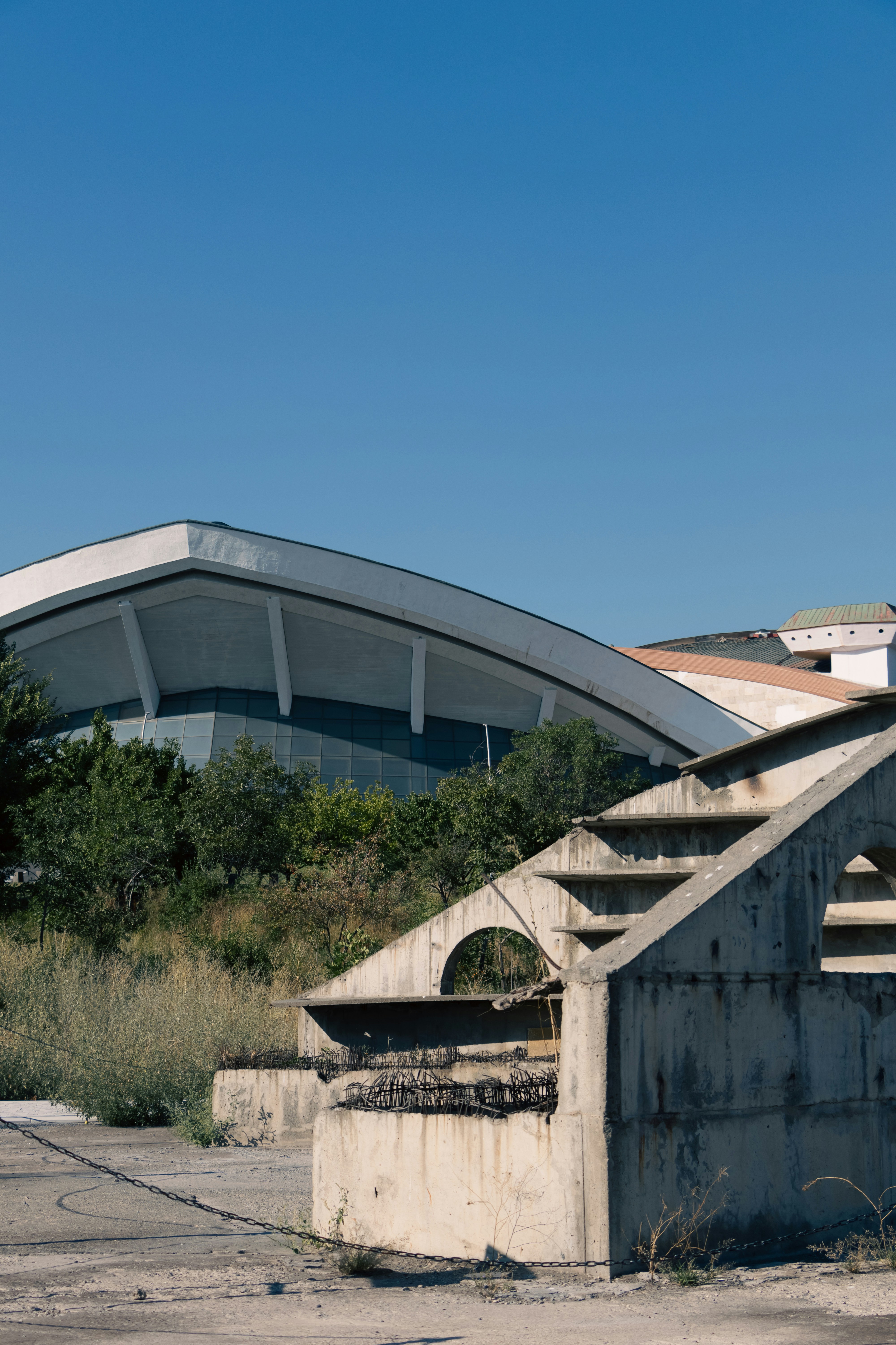 A concrete structure with a building in the background