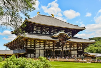 A large wooden building sitting on top of a lush green field