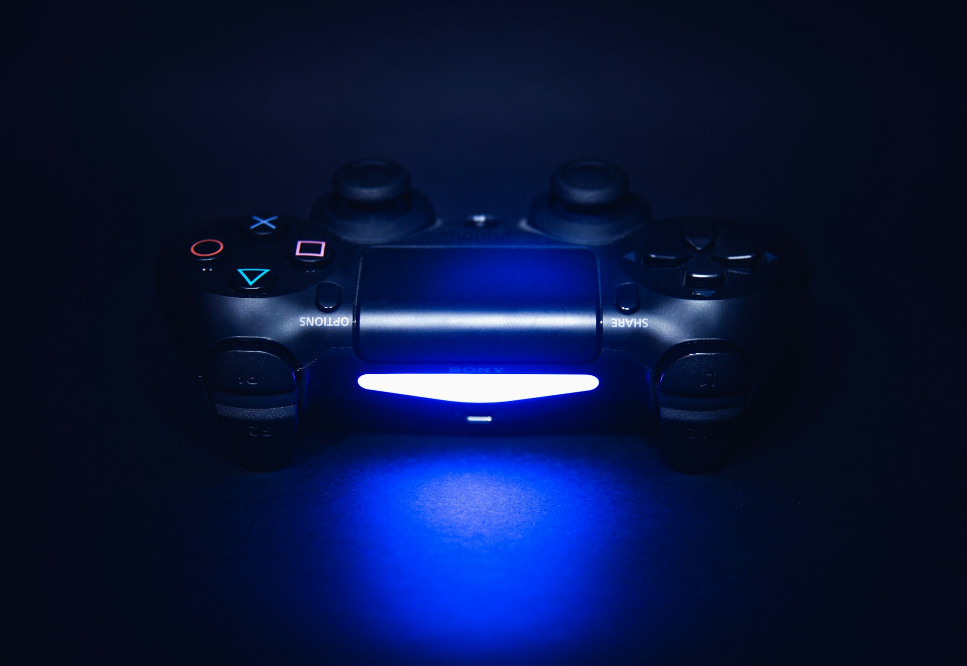 A video game controller lit up in the dark