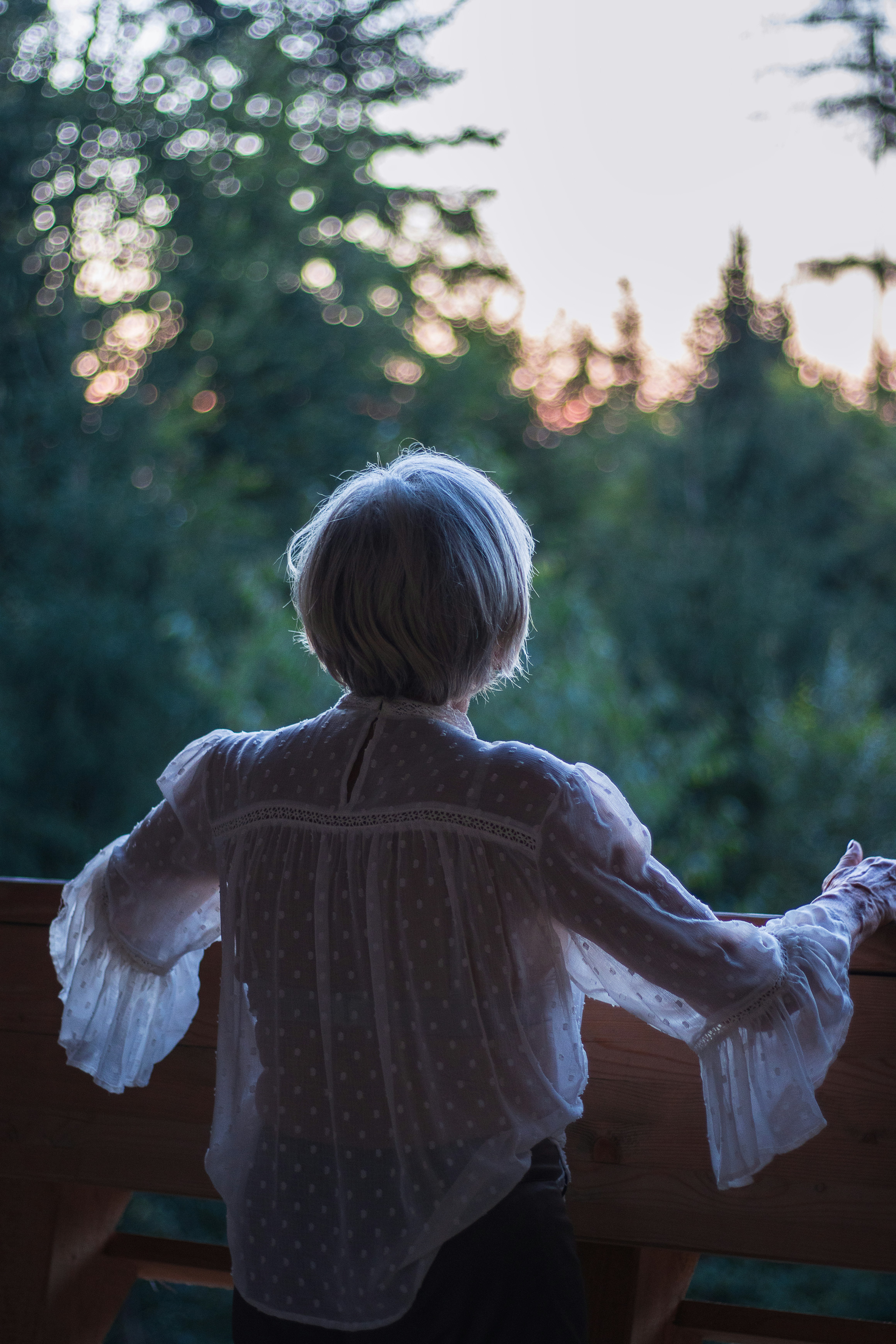 A little girl that is standing on a balcony