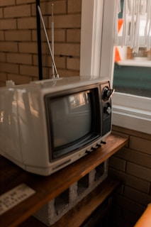 A small TV sitting on top of a wooden table